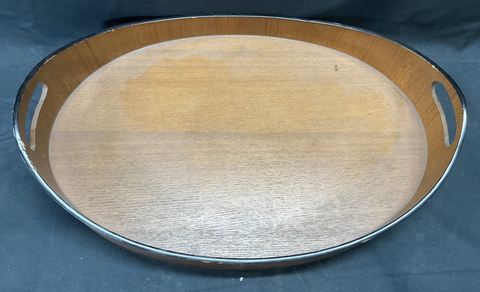 Vintage Oval Wooden Tray with Handles: Vintage oval shaped wooden tray with handles. Measures approx. 15 x 10 x 3.5 inches. Some surface wear including scratching observed. Tray, wooden tray, tray with handles, oval tray, tableware, table 