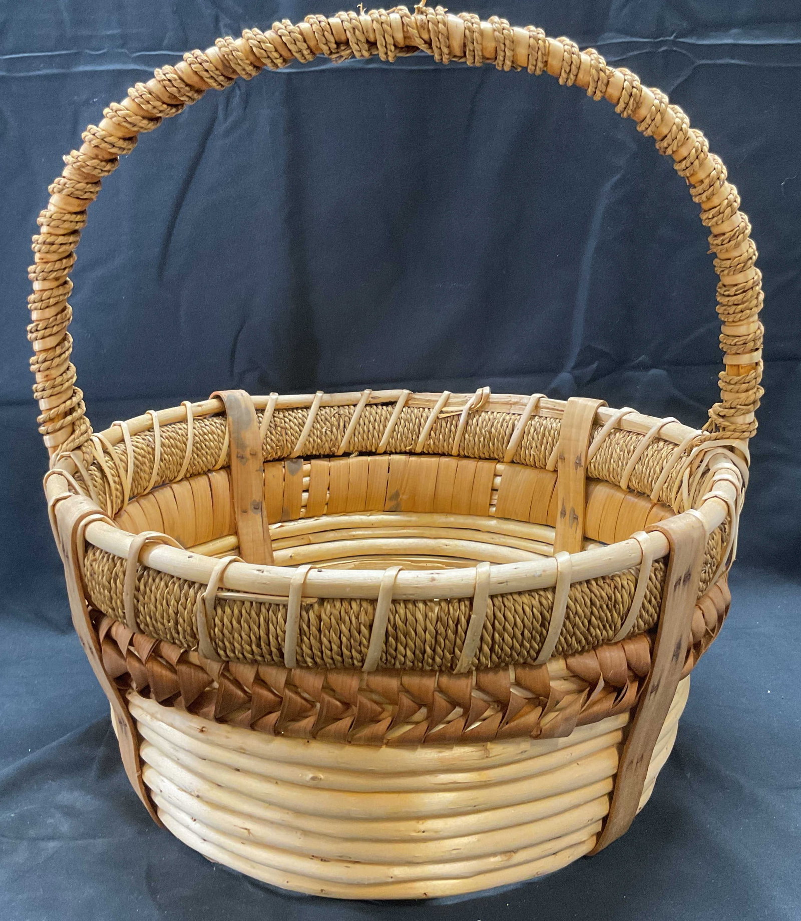 Bentwood & Woven Basket, 14 Inches Wide: Bentwood basket with woven and twister rope detail. Measures approx. 14 x 16 inches. Some wear to wood consistent with exposure. Basket, wood basket, bentwood basket, woven basket, round basket, stora