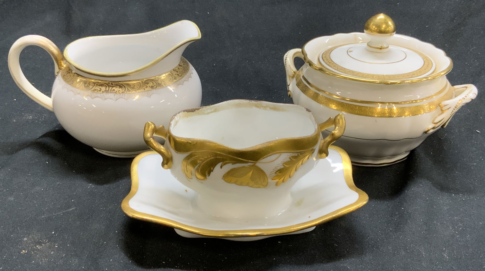 Lot3 Gilt Porc Vessels, Mintons, Nippon, Stouffer: Lot includes 1 sugar dish with lid marked MINTONS on underside, 1 creamer dish marked NIPPON & 1 vessel appears to be marked STOUFFER. Sugar dish with lid and handles measure approximately 4.75 inches