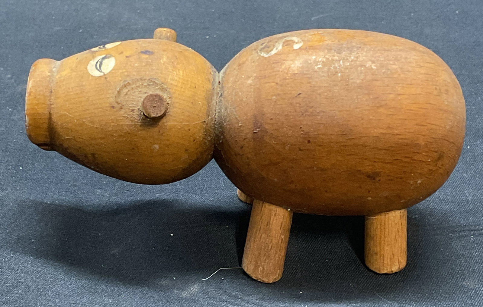 Vintage Wooden Pig Figural: Vintage wooden pig figural with hand painted decoration. Measures approx. 3.75 x 1.5 x 2 inches. Surface wear including scratching and residue observed. Pig. Pig figural, wood pig, decorative arts, ho