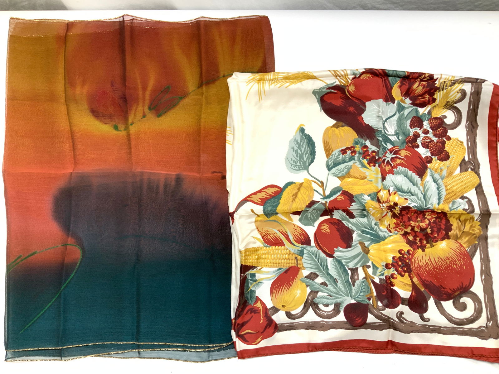 Jones New York Silk Scarf Italy, Silkland Scarf, 2: Jones New York hand rolled silk scarf, made in Italy. Signed scarf with autumn fruit and gourd motif in fall colors. Label attached to item. Measures 35 x 35 in. Silk Land Autumn colored polyester sca