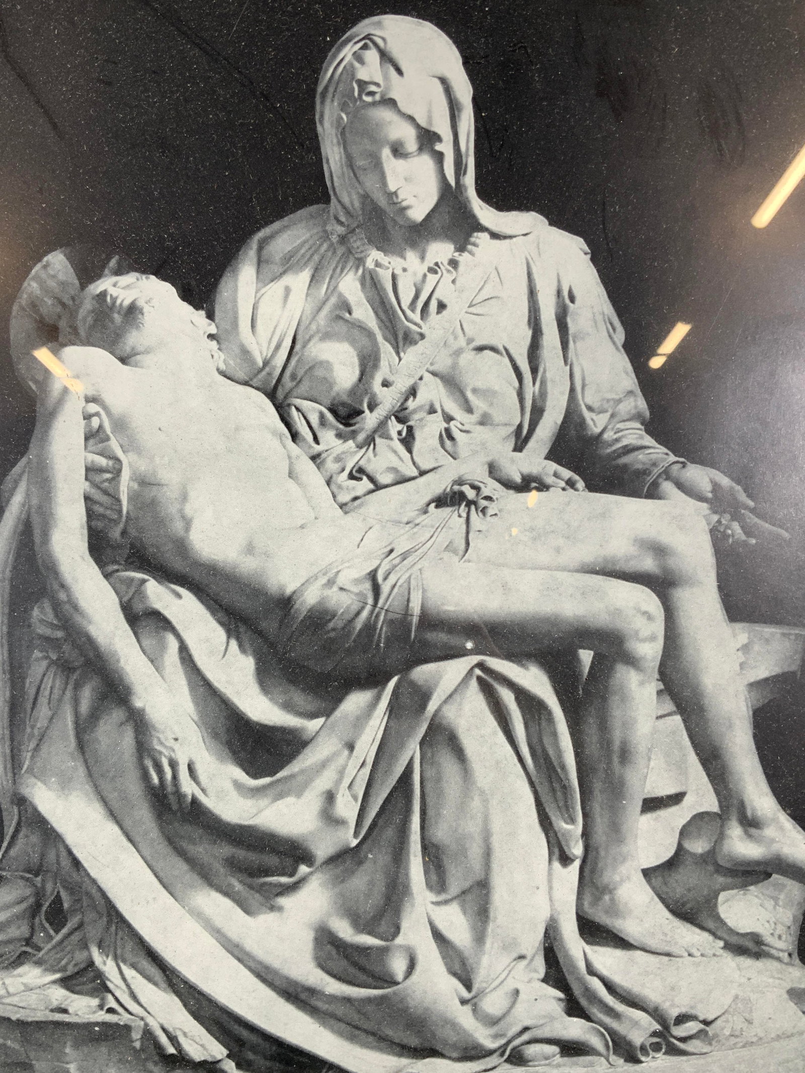 Michelangelo The Madonna della Pieta Photograph: Black and white photograph. Subject depicts a sculpture by Michelangelo. Sculpture titled The Madonna della Piet?. Subject depicts Mary holding her son Jesus after his crucifixion. Framed in a silver 