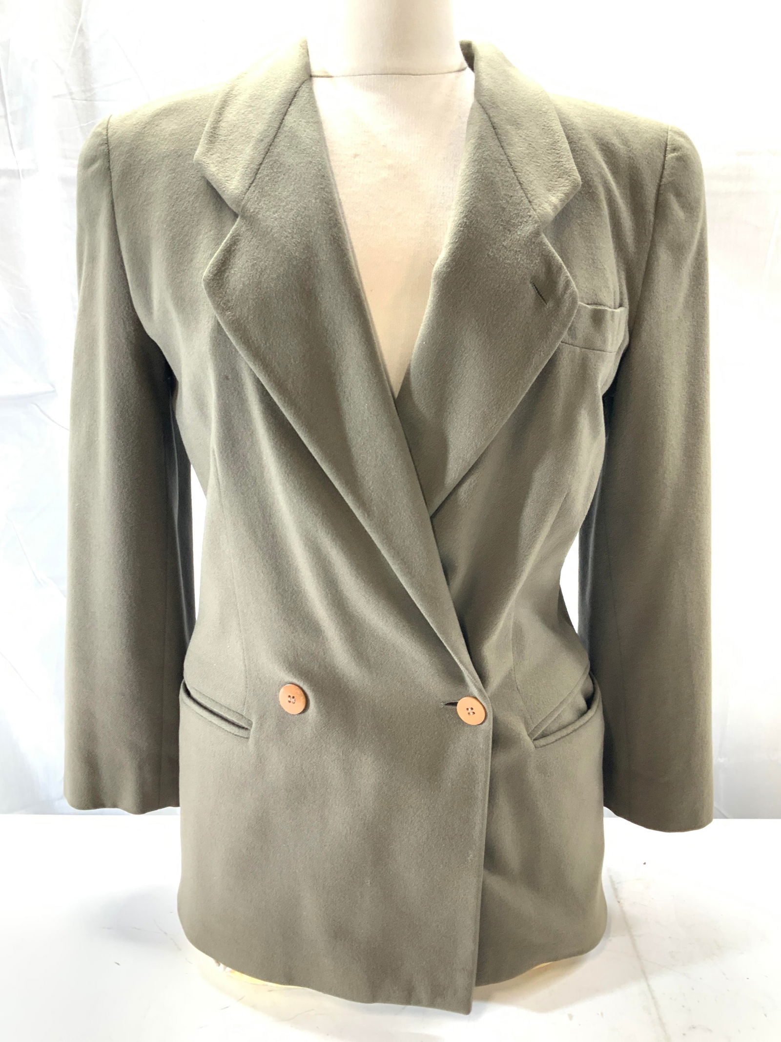 Giorgio Armani Cashmere Blazer, Italy: Army green cashmere double breasted blazer. Labeled Giorgio Armani A Milano Borgonuovo 21. Sewn in shoulder pads. 25.75 in. Long.. hips 36.5 in. Waist 31 in. Minor spot on breast. Girorgio Armani cash