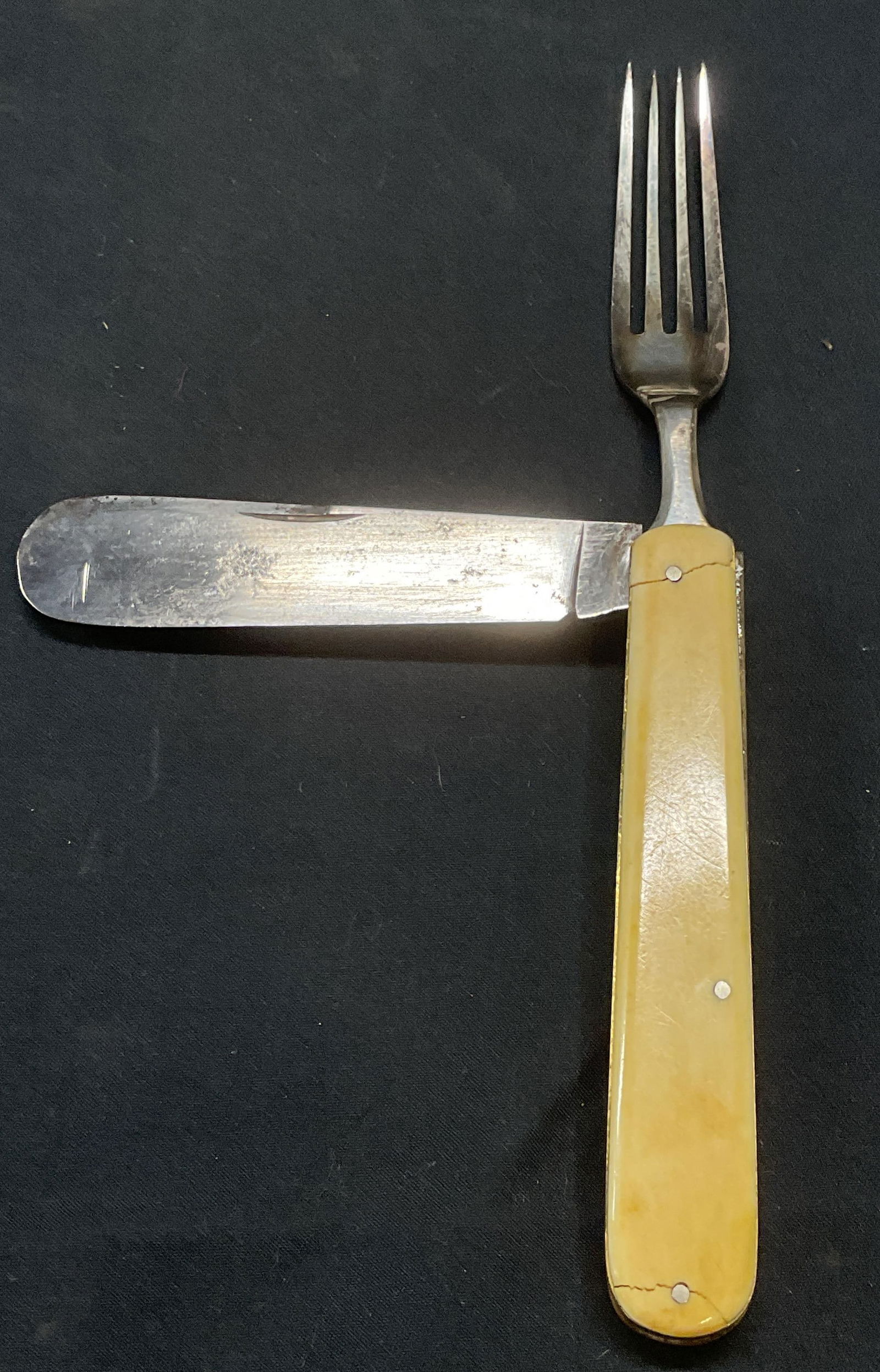 Vintage WM & S Folding Pocket Knife & Fork: A vintage WM & S folding pocket knife and fork. Bone and metal. Measures approx. 7.5 inches with fork extended. Trademarked on fork. Surface wear including chipping and scratching observed. Folding po