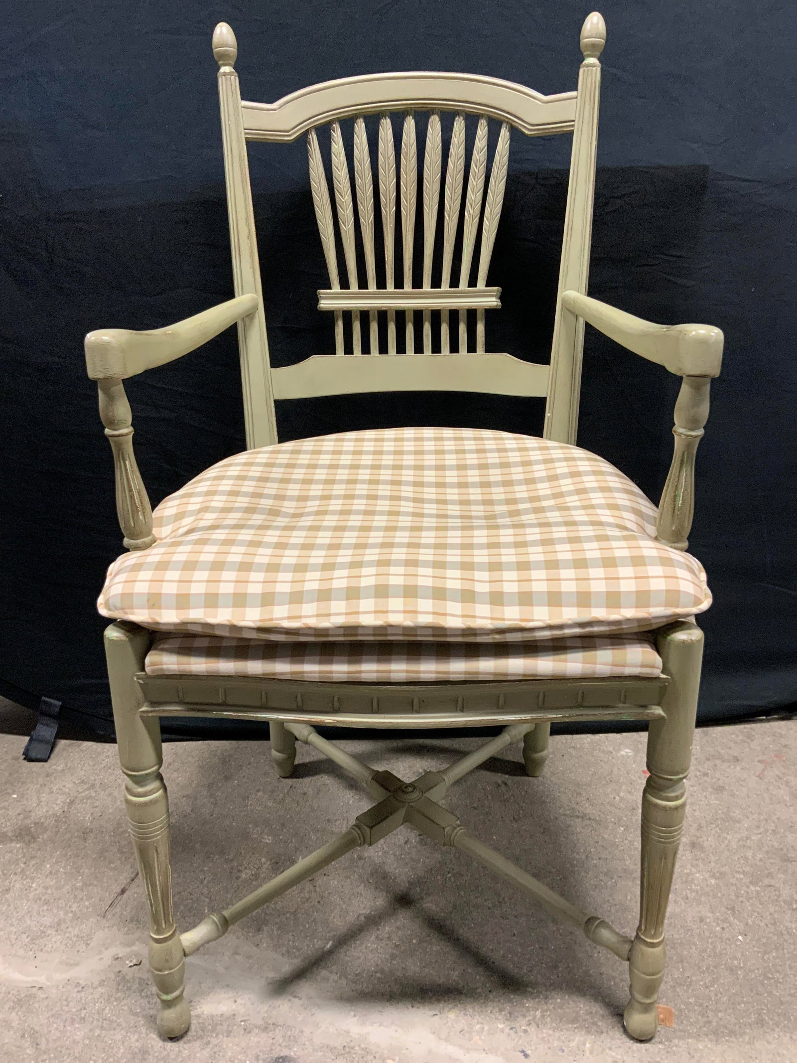 Vntg Wooden Spindle Back End Chair W Seat Cushion: Chair is vintage and wooden. Piece has spindle backrest. Chair is light olive toned. Chair has cream & olive toned plaid upholstered seat cushion. Measures approximately 40 inches tall 22 inches wide 