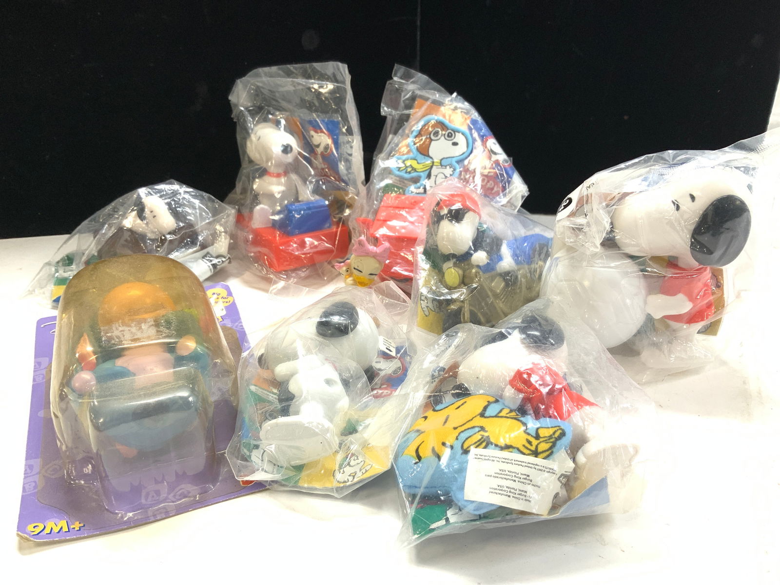 Grp 10 Burger King Snoopy Toys NIP +: Group of 8 promotional Burger King Snoopy toys, New In Package. Snoopy on the piano. Snoopy working a cash register. Snoopy with a soccer ball ( this snoopy guru Al measures 4 x 2.5 in. Snoops dog hou