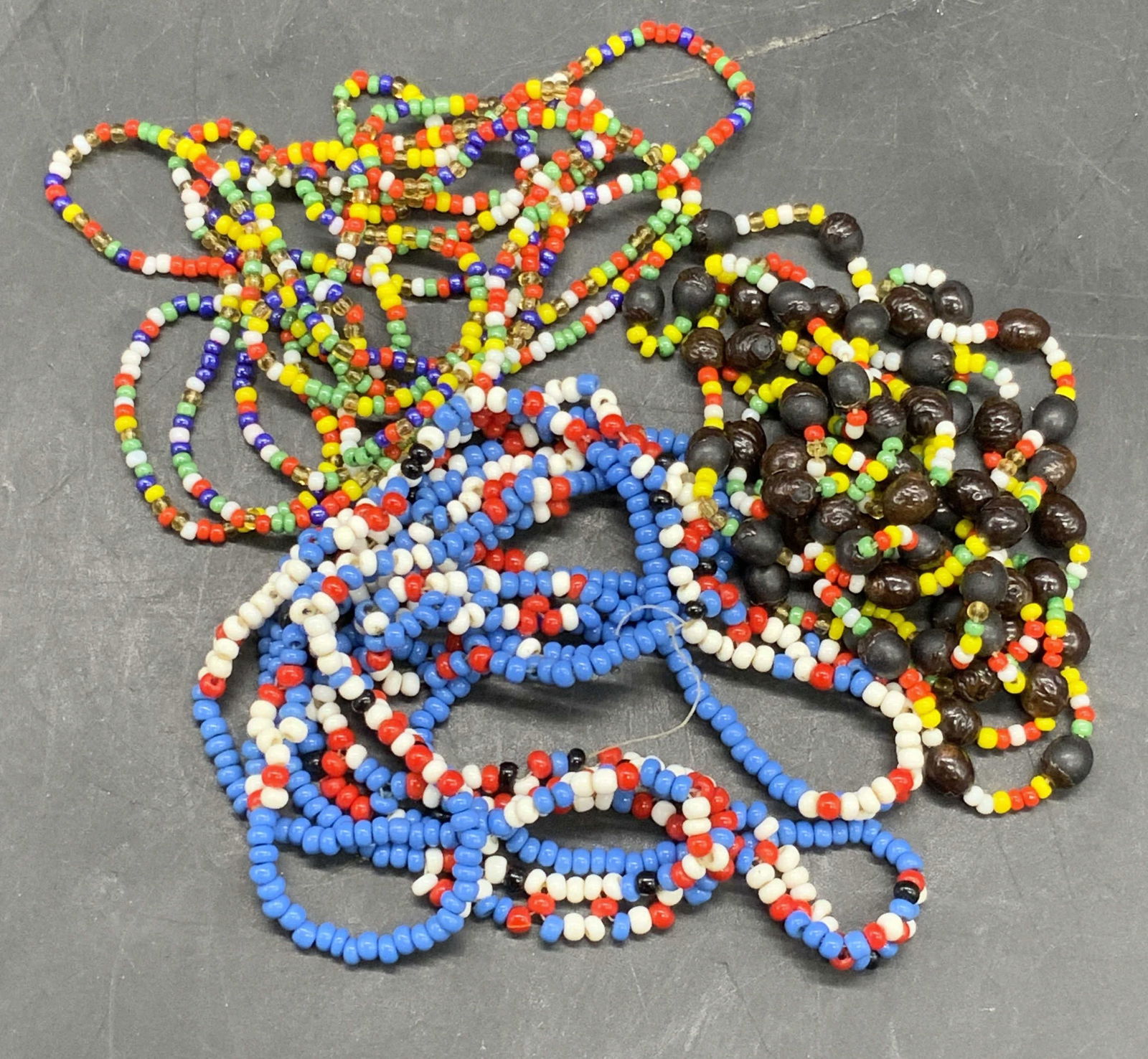 Lot 3 Seed Beaded Necklaces & Beaded Strands: A lot consisting of multicolored seed beaded necklaces and a beaded strand. The necklace strand measures approx. 35 inches in length end to end. Some surface wear consistent with age, use, and exposur