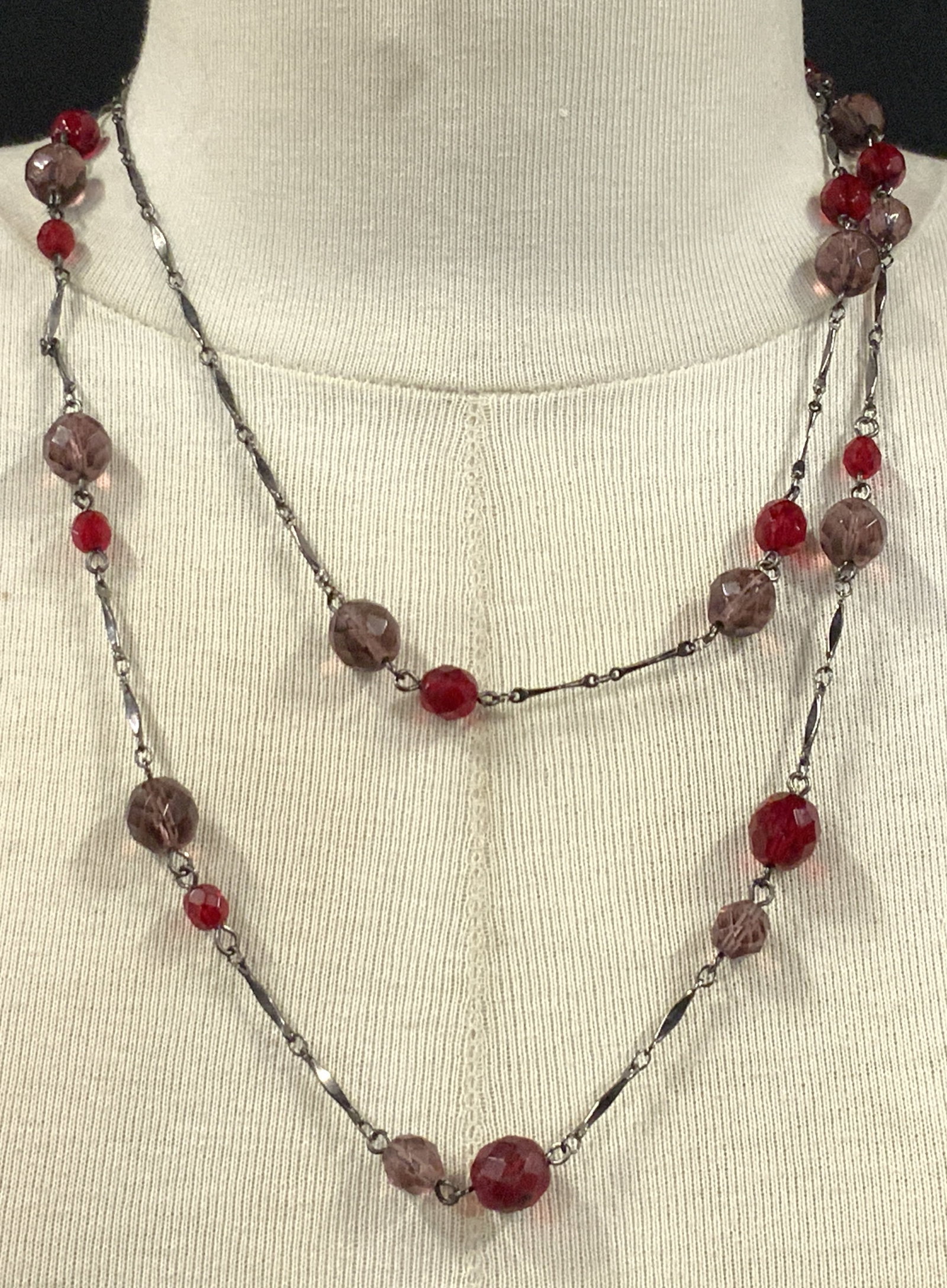 Vintage Faceted Crystal Bead Necklace, Jewelry: A vintage gunmetal toned necklace featuring faceted crystal beads. The beads are red and purple hued. Necklace measures approx. 42 inches, measured end to end. Some surface wear consistent with age, u