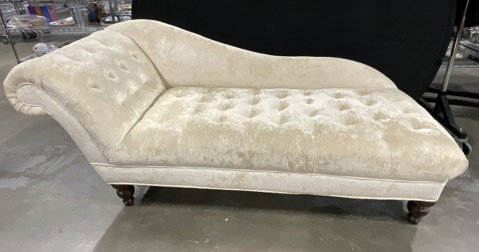 Tufted Upholstered Chaise Lounge W/ Wooden Feet: Tufted Upholstered Chaise Lounge W/ Wooden FeetSoft hand upholstered chaise lounge. Covered in silk linen velvet upholstery. Tufted. Cream hued upholstery. Rich brown wooden feet. Measures approx. 32D