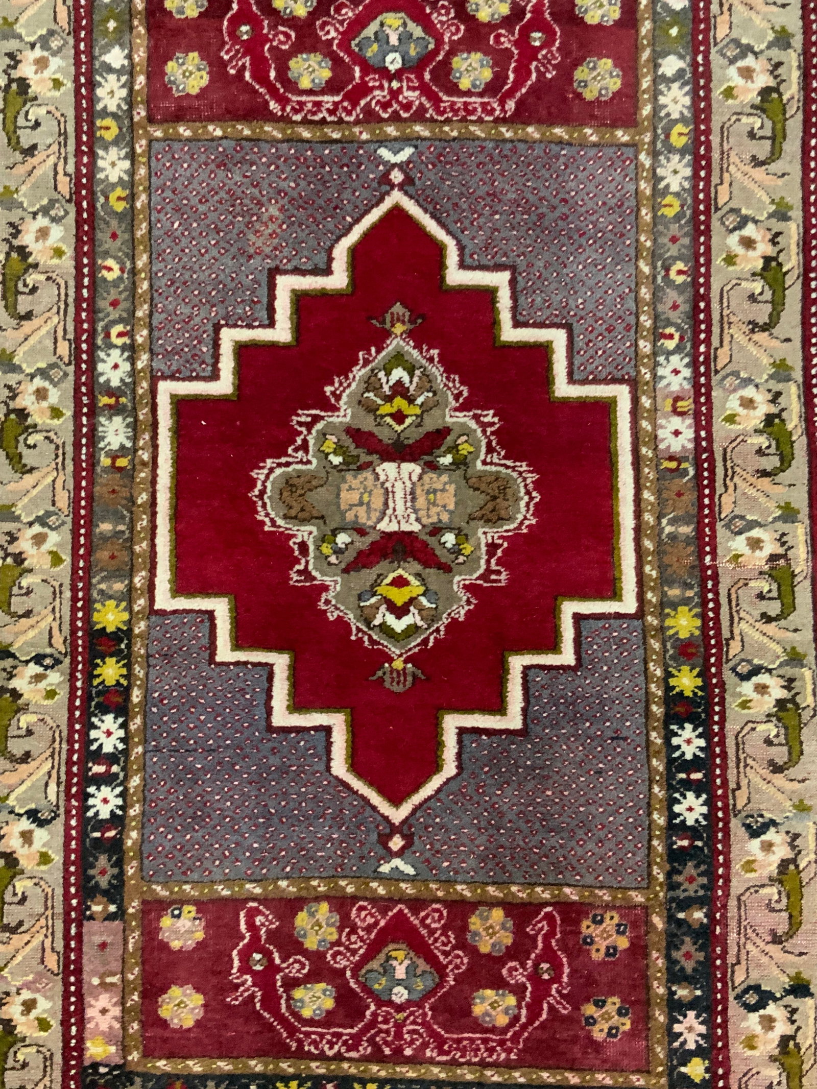 Vintage Turkish Medallion Floral Motif Rug: A vintage Turkish rug. Medallion to the center. Floral and geometric patterns throughout. Fringe trim. Measures approx. 39.5W x 64L in. Measurement includes fringe. No material tag present, possibly w