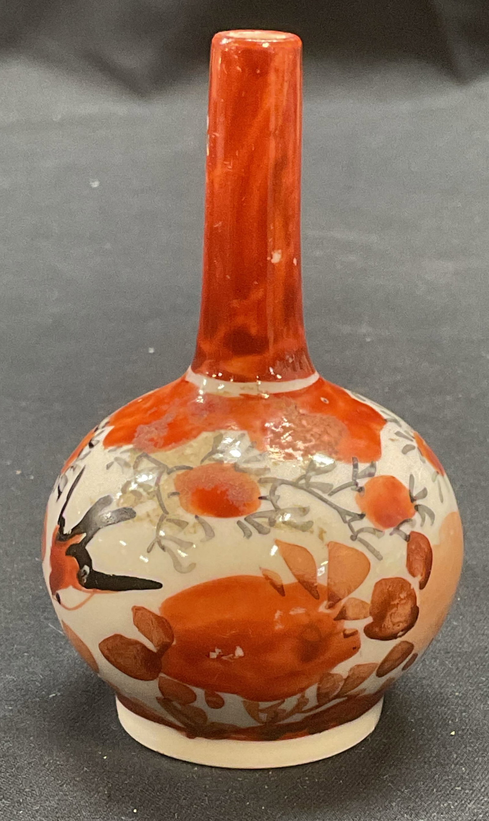 Antique Japanese Kutani Porcelain Bud Vase: Antique Japanese Kutani porcelain Bud vase. Hand painted with botanical motif in red and white. Antique circa mid 19th century. Measures approx. 2 x 3.25 inches. Some surface wear including scratching