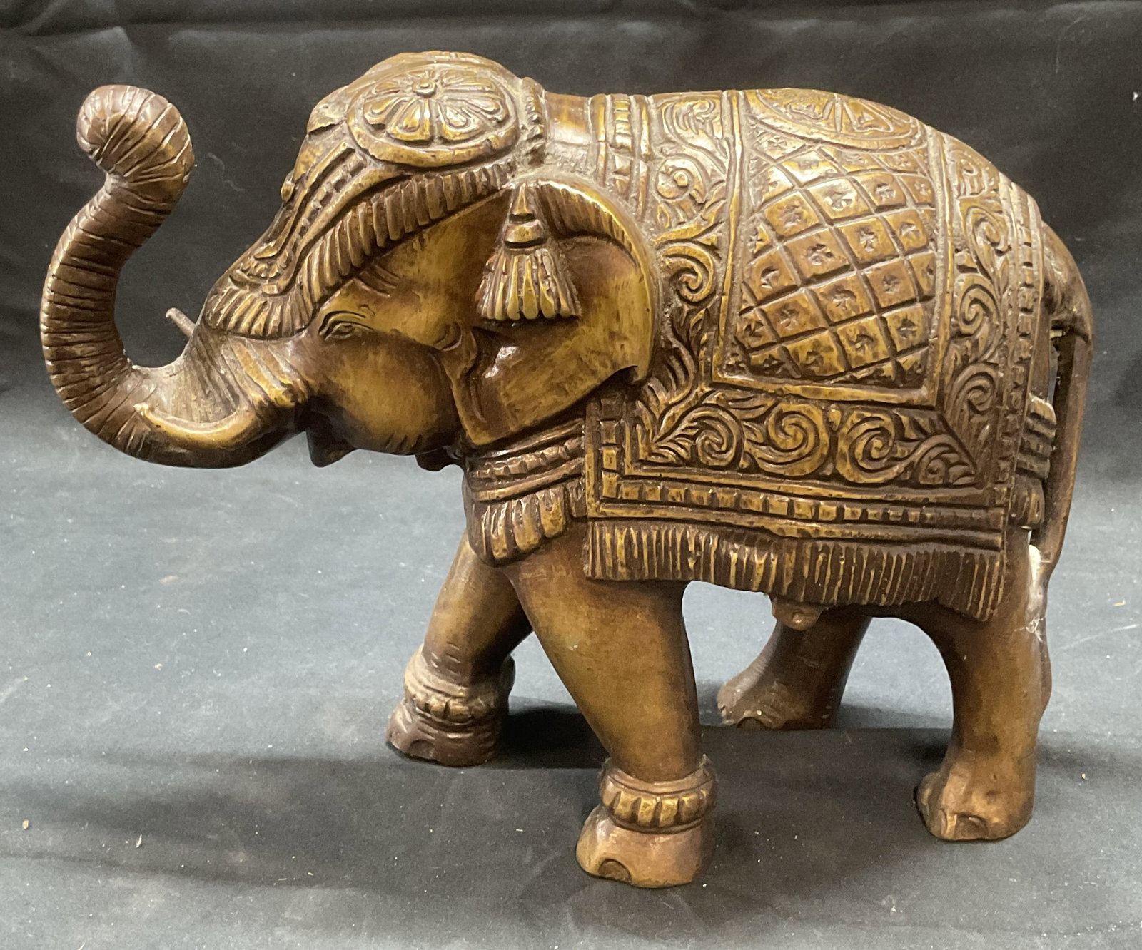 Vintage Bronze Elephant Figural: Vintage bronze elephant figural. Raised ornate decoration. Piece is heavy. Measures approx. 10 x 4 x 7.5 inches. Some surface wear consistent with exposure. Elephant, bronze elephant, elephant figural