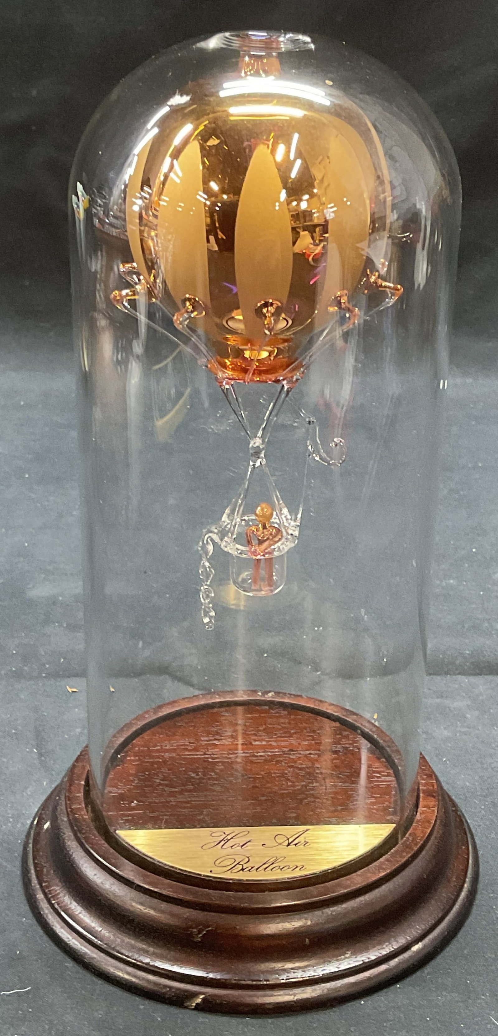 Vintage Gilt Art Glass Hot Air Balloon Sculpture: Vintage art glass sculpture with dome case. Hot air balloon with figure motif. Gilt decoration. Total dimensions approx. 4.5 x 7.5 inches. Some surface wear consistent with exposure. Hot air balloon, 