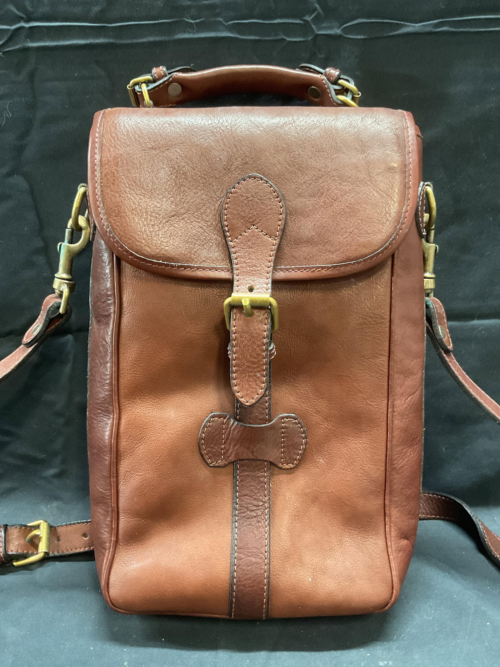 Brag Wear Brown Leather Insulated Bag, Canada: Brag Wear brown leather bag with front flap closure and buckle. Insulated interior with two fitted pockets and removable partition. Signed on interior. Exterior marked Bounty Hunter Rare Wine Provisio