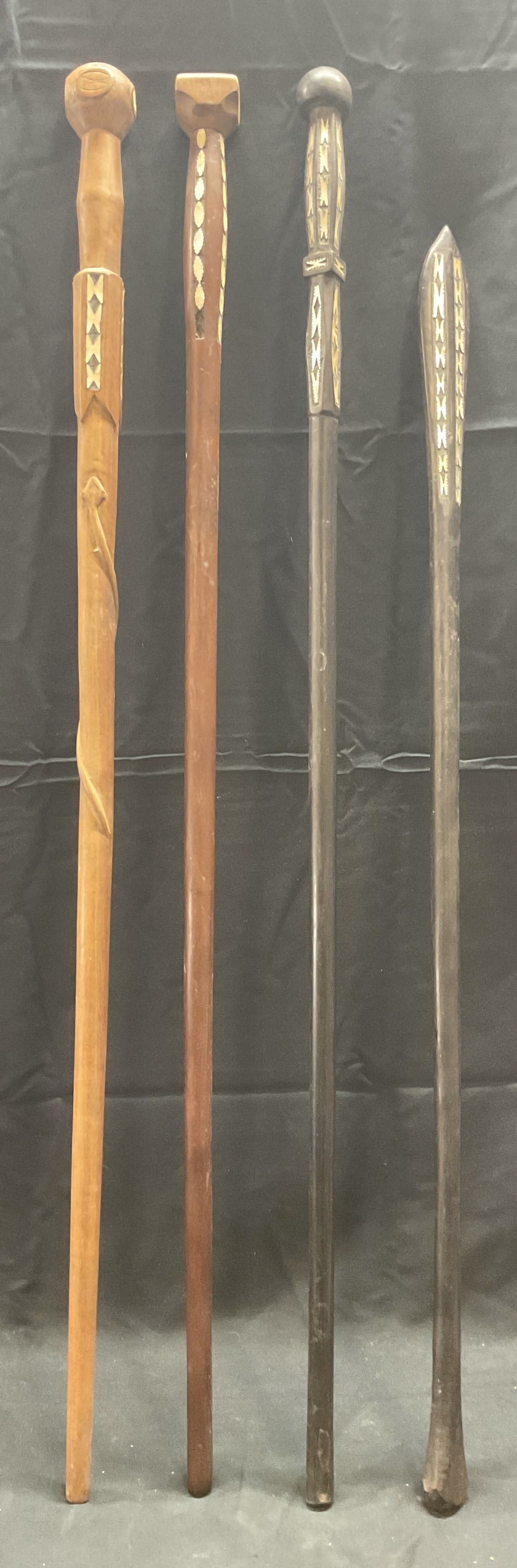 Lot 4 Vintage Wooden Walking Sticks with MOP: Lot of 4 vintage carved wood canes/walking sticks with inlaid mother of pearl decoration. One piece with carved snake detail. Longest piece measures approx. 34.75 inches long. All pieces have surface