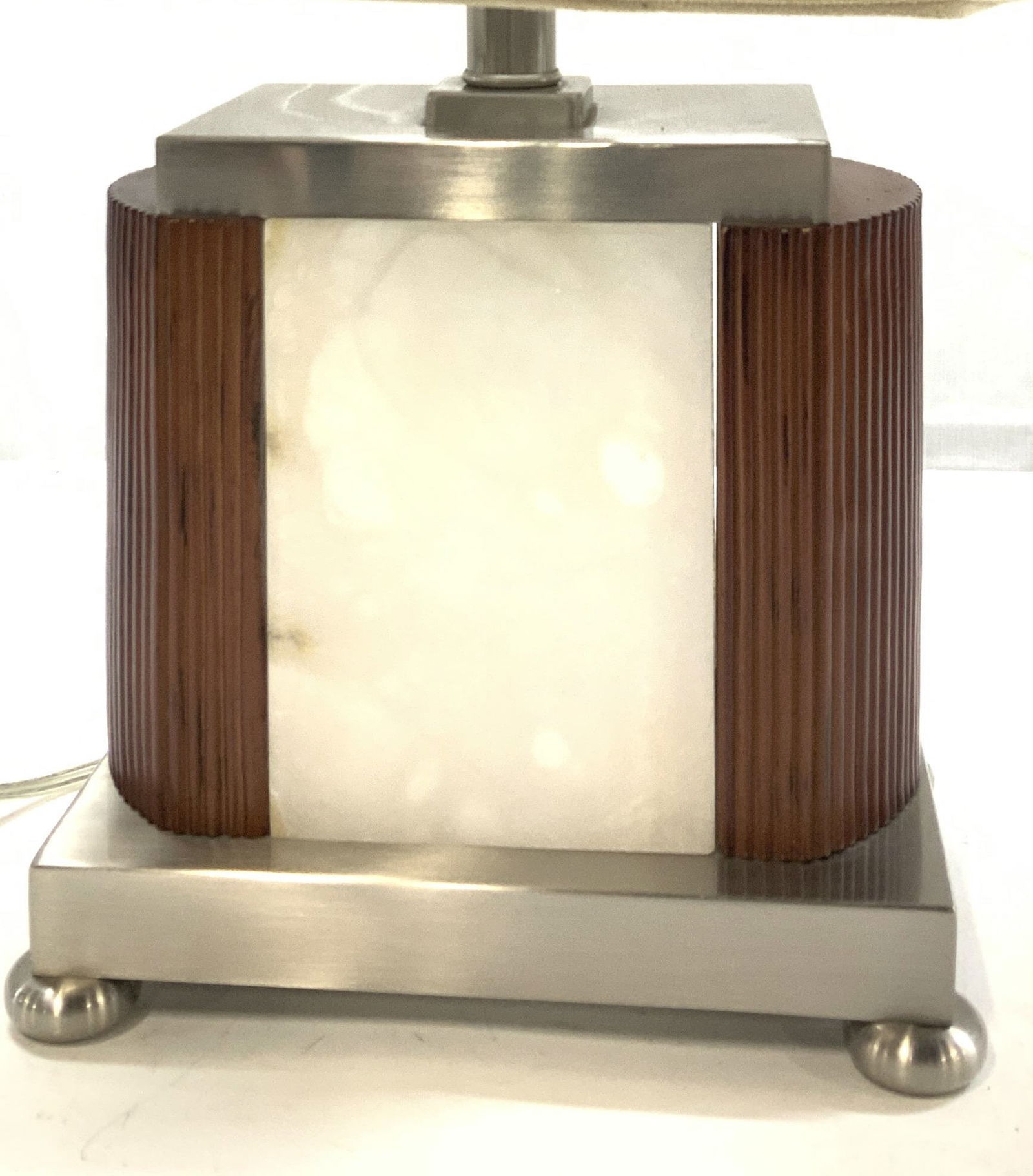 3 way Soapstone, Wood, & Stainless Portable Lamp: Footed lamp on a stainless steel base with square stainless finial. Body of lamp has an interior light in center of white soapstone ( natural stone, possibly soapstone) , flanked by ribbed wood. Lamps