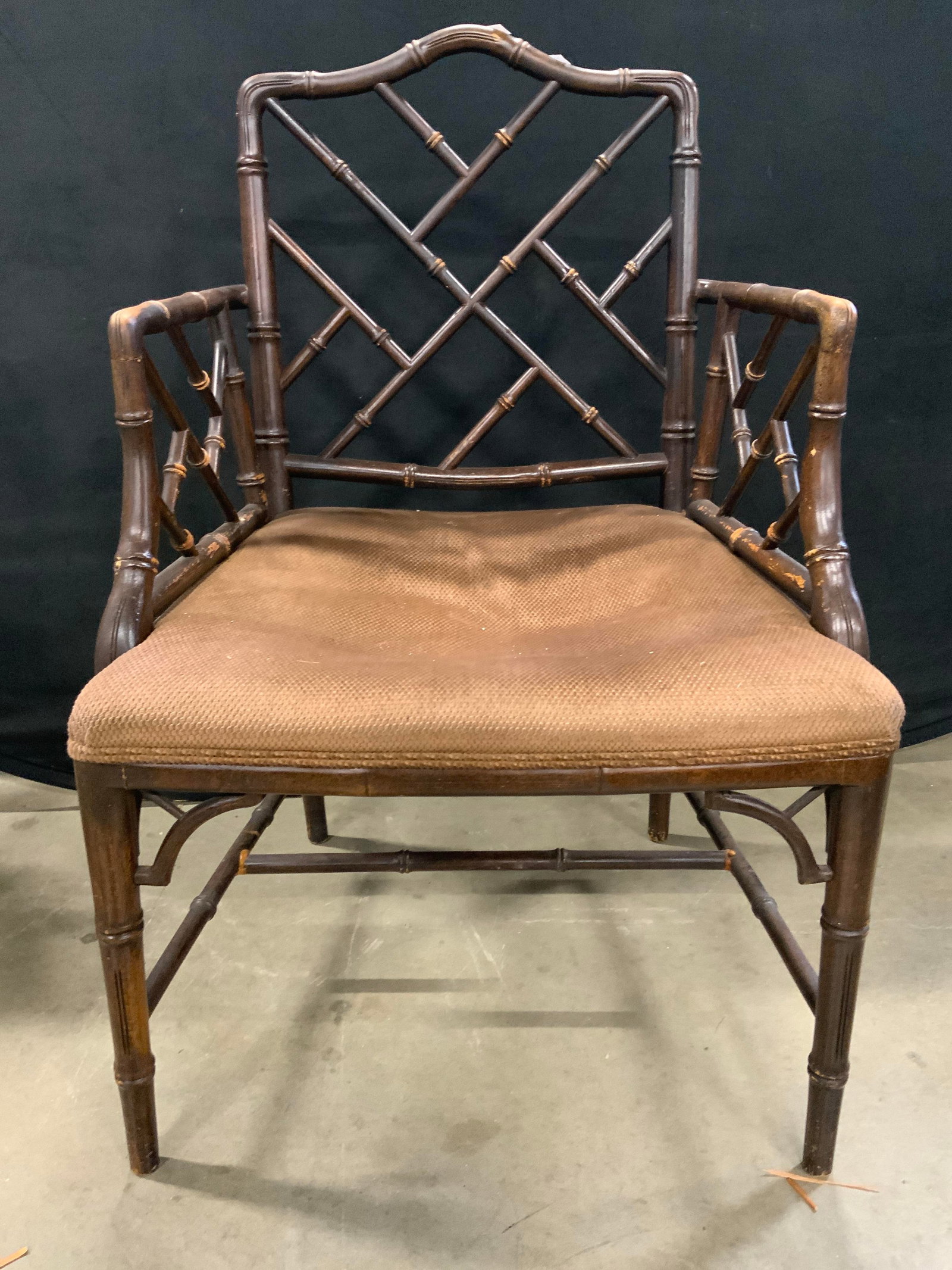 Vintage Chippendale Bamboo Style Upholstered Chair: A vintage Chippendale style armchair featuring an upholstered seat and faux bamboo. Dark wood finish. Soft hand upholstery. Measures approx. 22W x 19D x 35.5H in. Some surface wear consistent with age