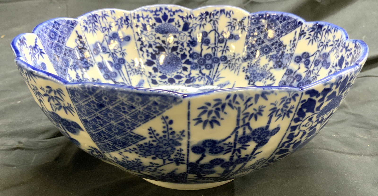 Asian Chinoiserie Vntg Porcelain Bowl Vessel: Bowl is vintage. Piece is porcelain. Vessel is white with intricate blue toned bamboo, floral, leaf, tree, & geometric detail. Bowl is scalloped. Piece measures approximately 10 inches wide 4.25 inche