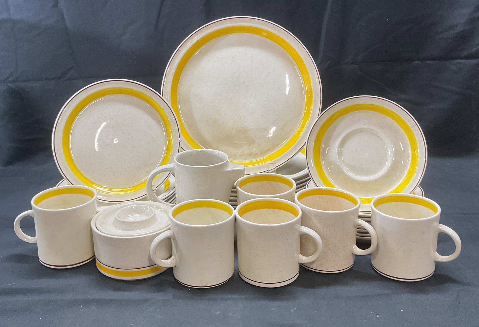 Set 31 Vntg Brendan Erin Stone Yellow Tableware: Set of 31 pieces vintage Brendan Erin stone tableware. Cream toned with yellow and brown striped borders. Includes 7 dinner plates, 8 luncheon plates, 8 saucers, 6 cups, 1 creamer, and 1 covered sugar