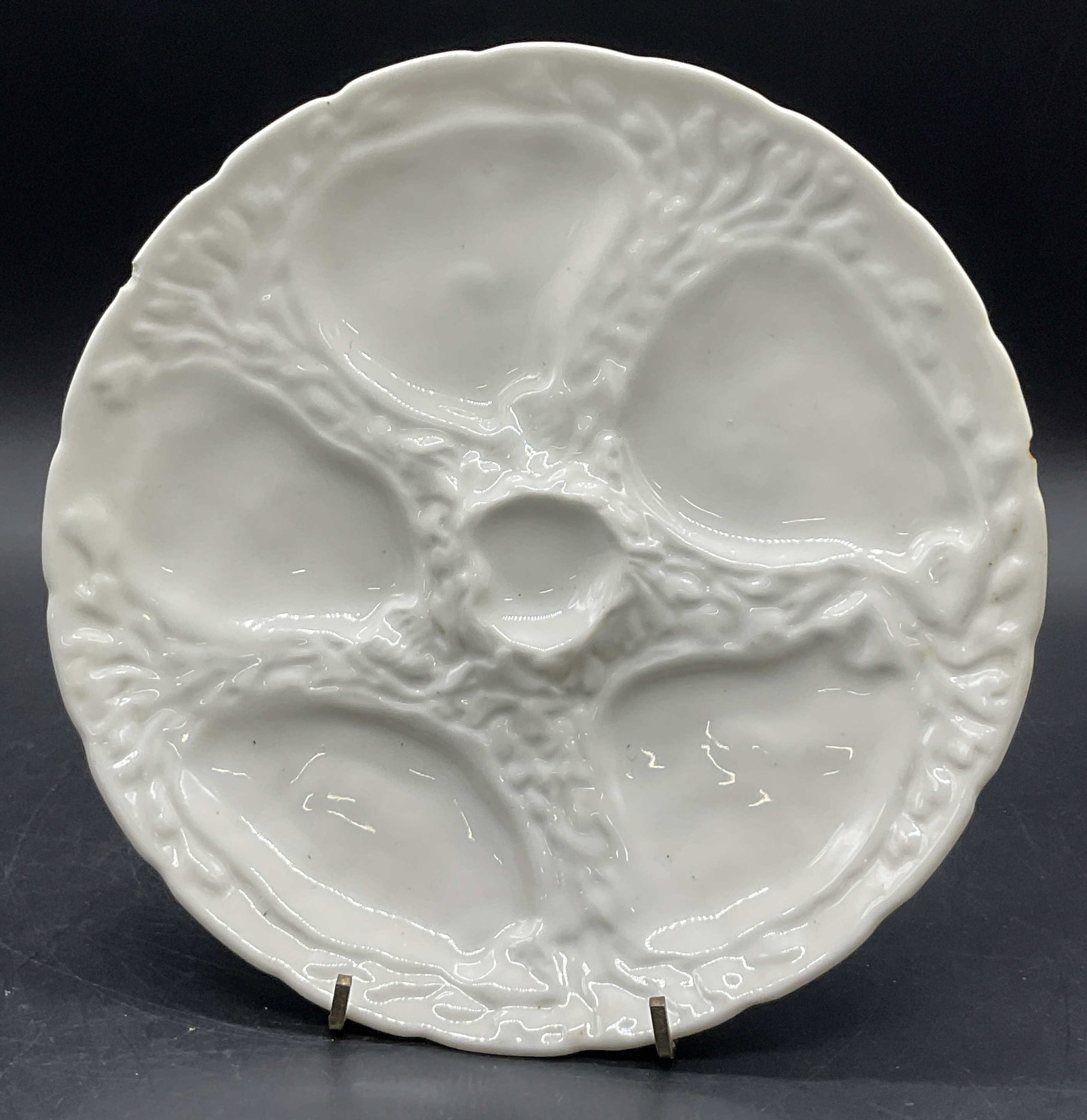 KT & K Signed Vintage Porcelain Oyster Plate: A vintage white porcelain oyster plate. Underside signed KT & K, CHINA. Measures approx. 8.5L x 8.5W in. Surface wear consistent with age, use, and exposure. Chipping and discoloration present. home d