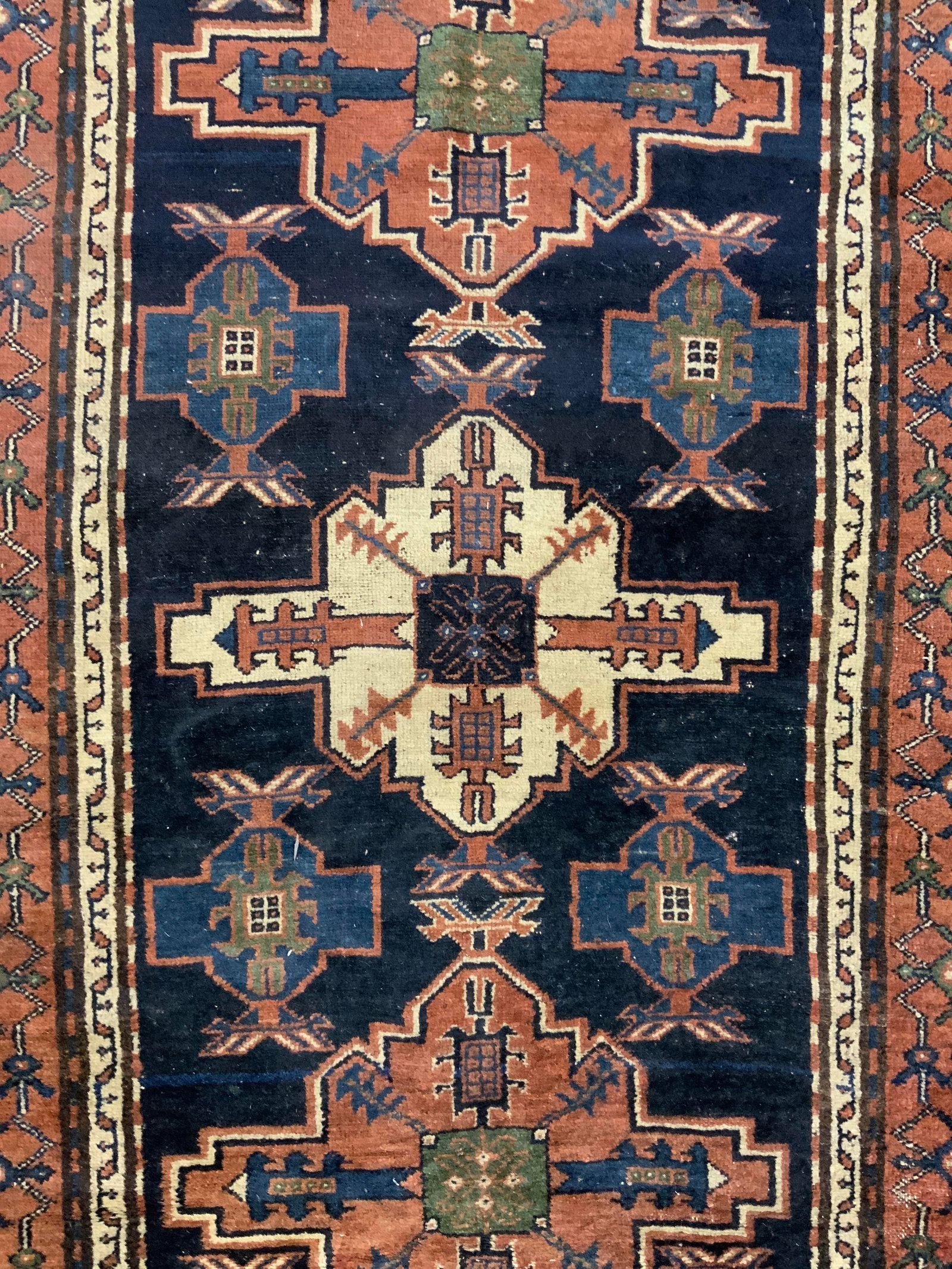 Vintage Handmade Persian Wool Rug: Rug is handmade and wool. Piece is vintage. Rug has intricate multi toned geometric detail. Some short cream toned fringes present. Piece measures approximately 78 inches long 50 inches wide. Rug, car