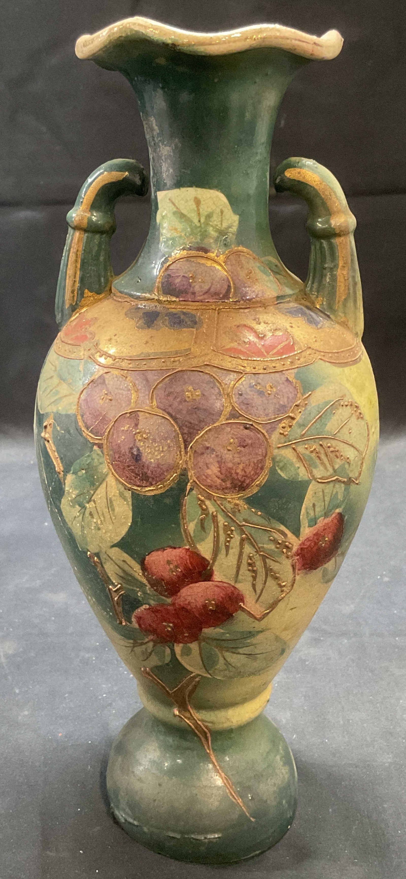 Vintage Gilt Ceramic Berry Urn Vase: Vintage ceramic urn shaped vase. Hand painted in green with gilt decoration and berry motif. Measures approx. 4.5 x 10.5 inches. Surface wear including scratching, crazing, and hairline cracks observe