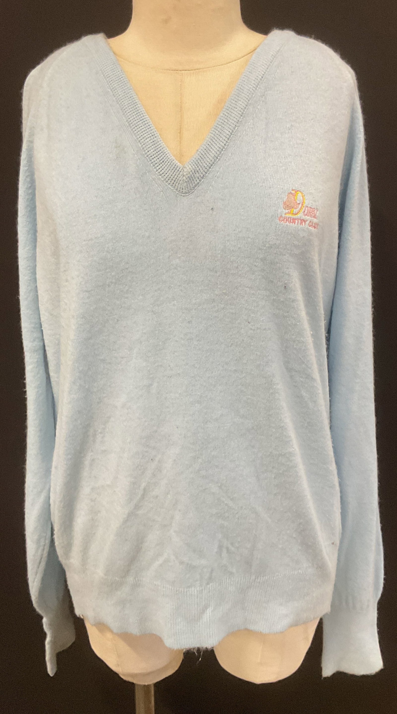 Doral Country Club Embroidered Blue Sweater: Doral Country Club v neck light blue sweater with embroidered detail on chest. Size XL. 100% acrylic. Wear to material including blemishes and pilling observed. Doral country club, Doral country club 