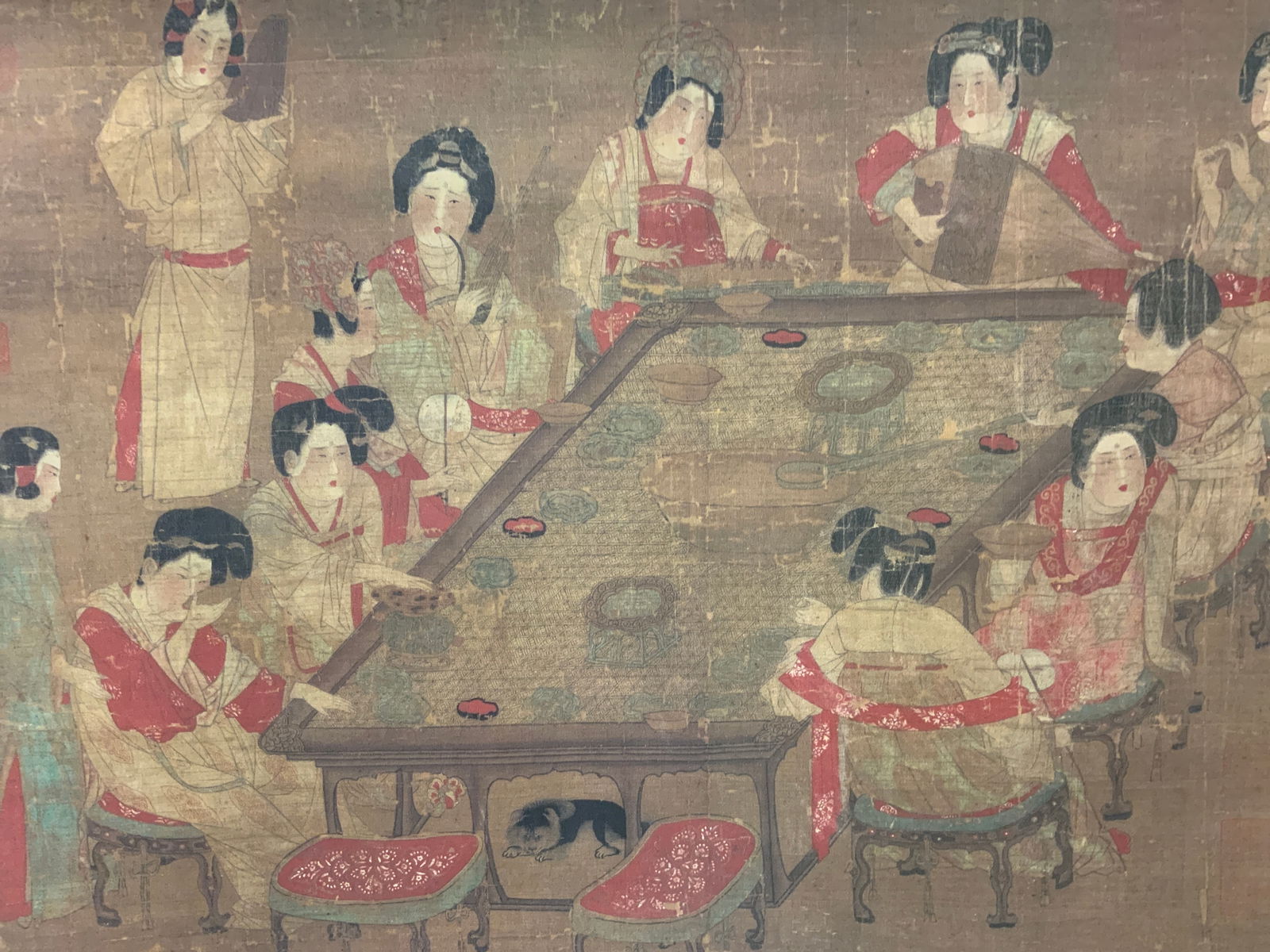 Asian Silk Scroll Hanging Palace Concert 71in: Giclee print. Based on the Tang Dynasty painting titled Palace Concert. Artist unknown. Subject depicts a ten woman sitting around a table with two standing servant maidens, they play instruments and