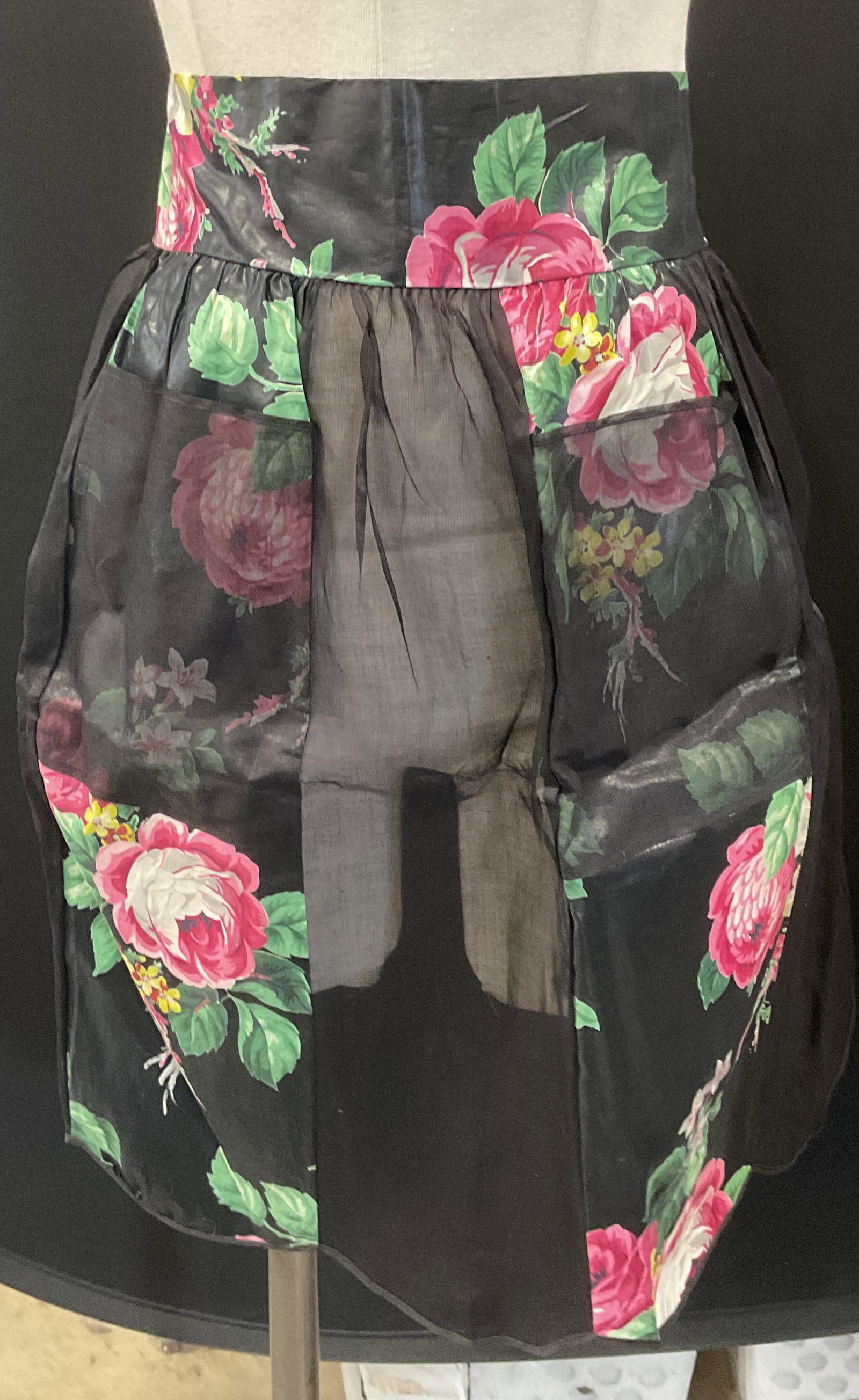 Vintage Black Sheer Floral Apron: Vintage black floral motif and sheer panel tie waist apron. Measures approx, 17 inches across waist paid flat. Material feels like cotton and synthetic. Some wear to material consistent with exposure.