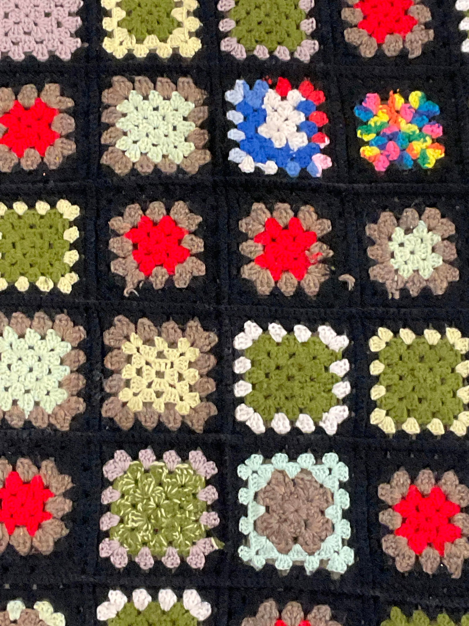 CAROLINE SCHOENBERG Vintage Hand Knitted Blanket: A vintage hand knitted multicolored blanket. Tag reads Hand Knit and Fashioned by CAROLINE SCHOENBERG. Measures approx. 72L x 40W in. Surface wear consistent with age, use, and exposure. Discoloration