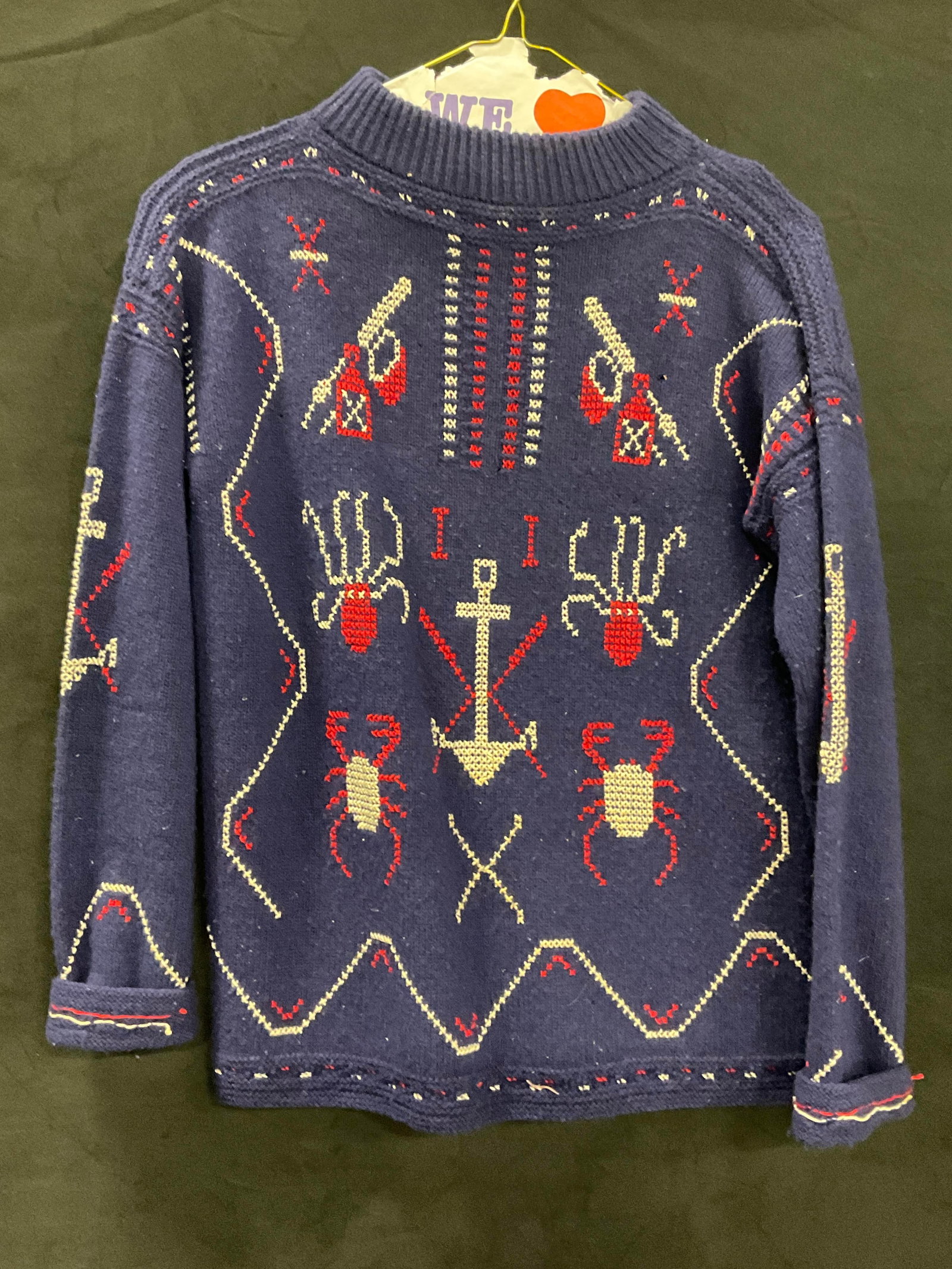 Vntg Hand Stitch Nautical Motif Embroidery Sweater: A vintage hand stitched sweater featuring nautical embroidery throughout. Anchors, octopuses, crustaceans and more to the design. Primarily red, white, and navy blue hues. Measured flat approx. 25.5 i