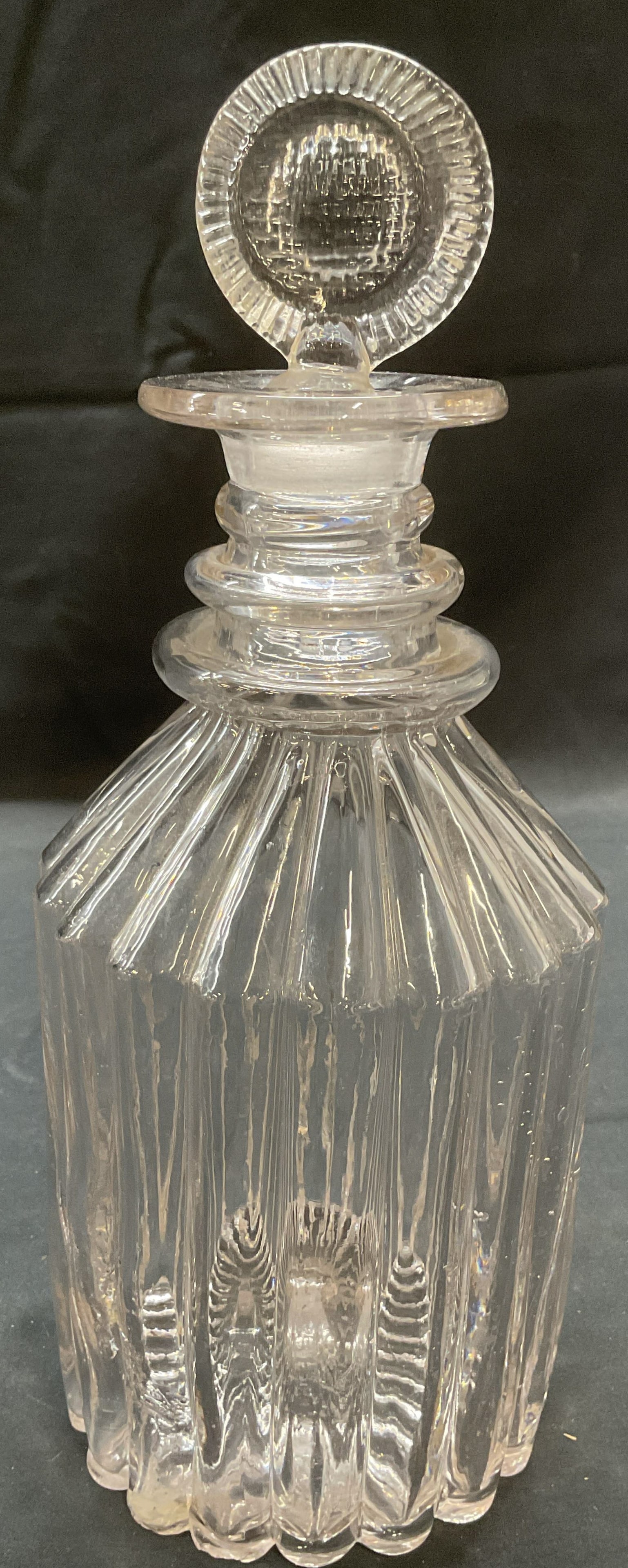 Vintage scalloped Ribbed Glass Decanter: Vintage glass decanter with ribbed scalloped design. Measures approx. 4.5 x 11 inches. Some surface wear including scratching and small chips observed. Repair on base observed. Decanter, glass decante
