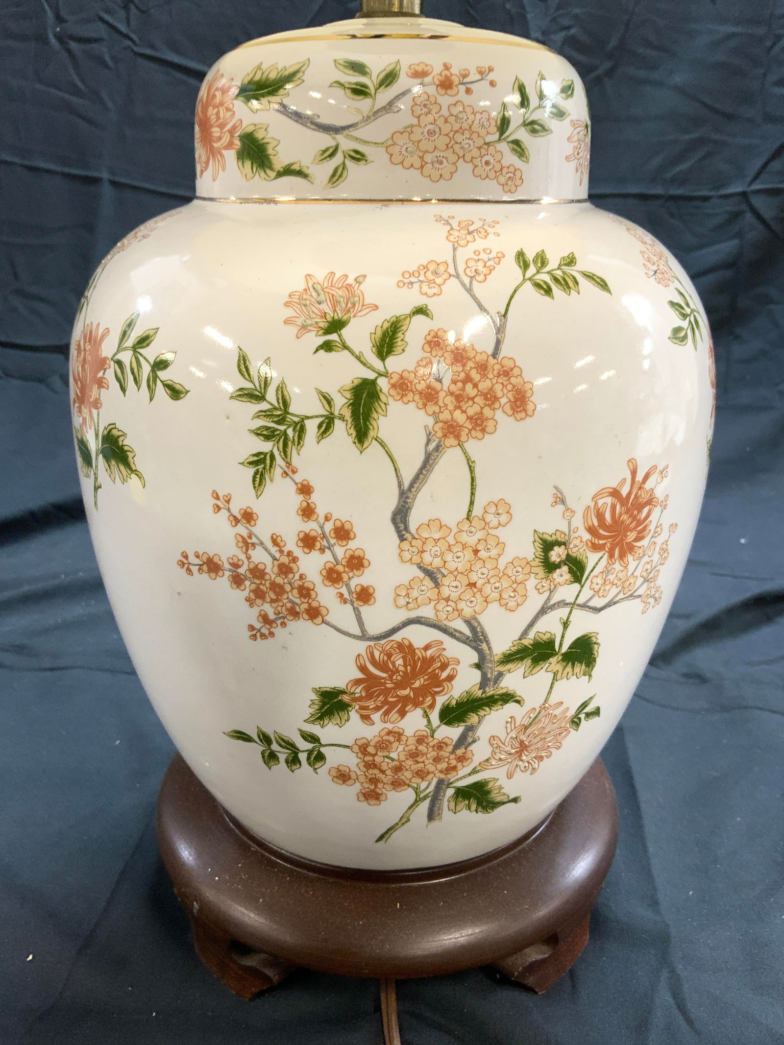 Vintage Floral Porcelain Lamp W Shade: Lamp is cream toned and porcelain. Piece has multi toned floral and leaf detail. Lamp has brown toned base. Lamp appears to be vintage. Lamp includes harp, finial & cream toned shade. Lamp measures ap