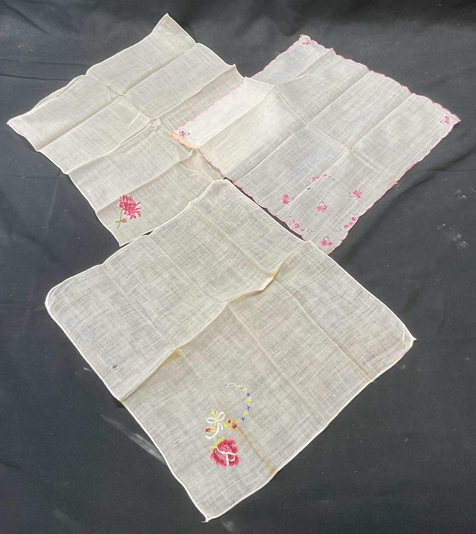 Lot 3 Vintage White & Pink Floral Handkerchiefs: Lot of 3 vintage white and pink handkerchief with embroidered floral motifs. Largest measures approx. 11 x 11 inches. All pieces feel like cotton. All pieces have some wear to materials including blem