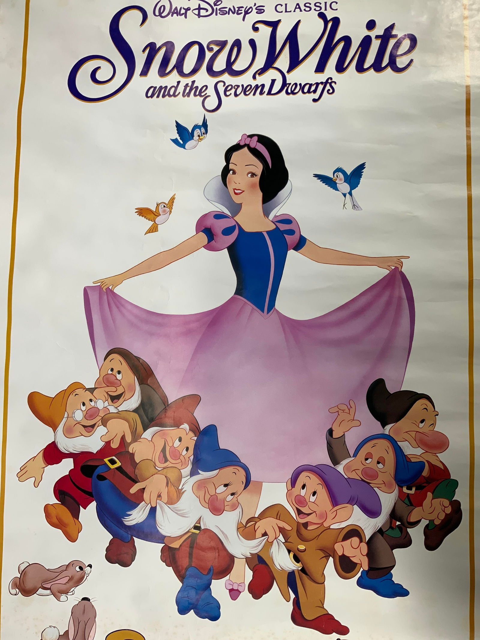 Vntg 1987 50th Anniversary Snow White Movie Poster: Lithograph on paper. Movie poster for the 50th Anniversary rerelease screening of Snow White and the Seven Dwarves in 1987. Subject depicts Snow White with her dress in her hands and the seven dwarves