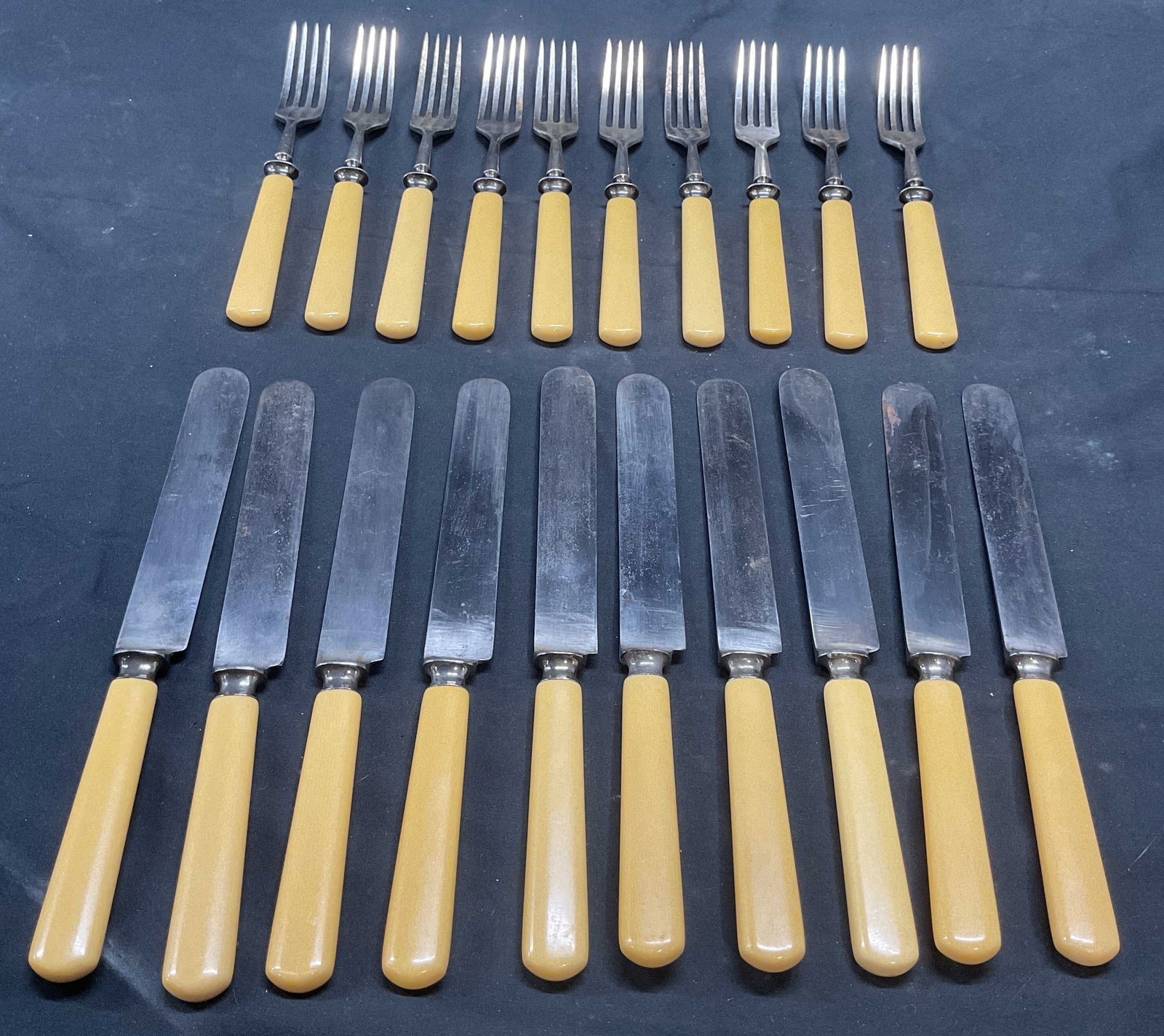 Lot 20 Landers Frary & Clark Faux Bone Knives +: Group of 20 flatware pieces. 10 vintage Landers Frary and Clark Aetna Works faux bone handle and silver placed knives. Signed on blades. Measure approx. 9 inches long. 10 faux bone handle and silver p