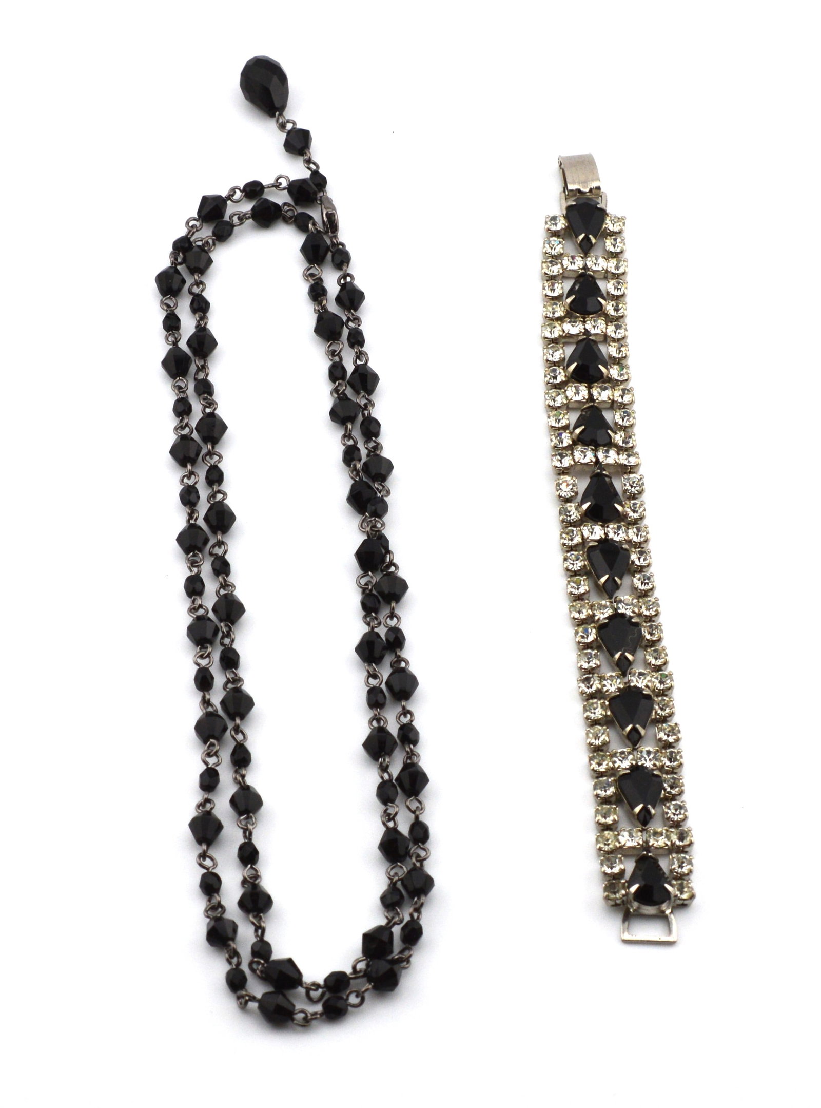 Vintage Necklace & Rhinestone Bracelet: The black faceted bead necklace with antiqued metal is 32 in long and adjustable. The rhinestone bracelet is in beautiful condition. It is 7 in long with a hinge and clasp closure.PREOWNEDNBBS12