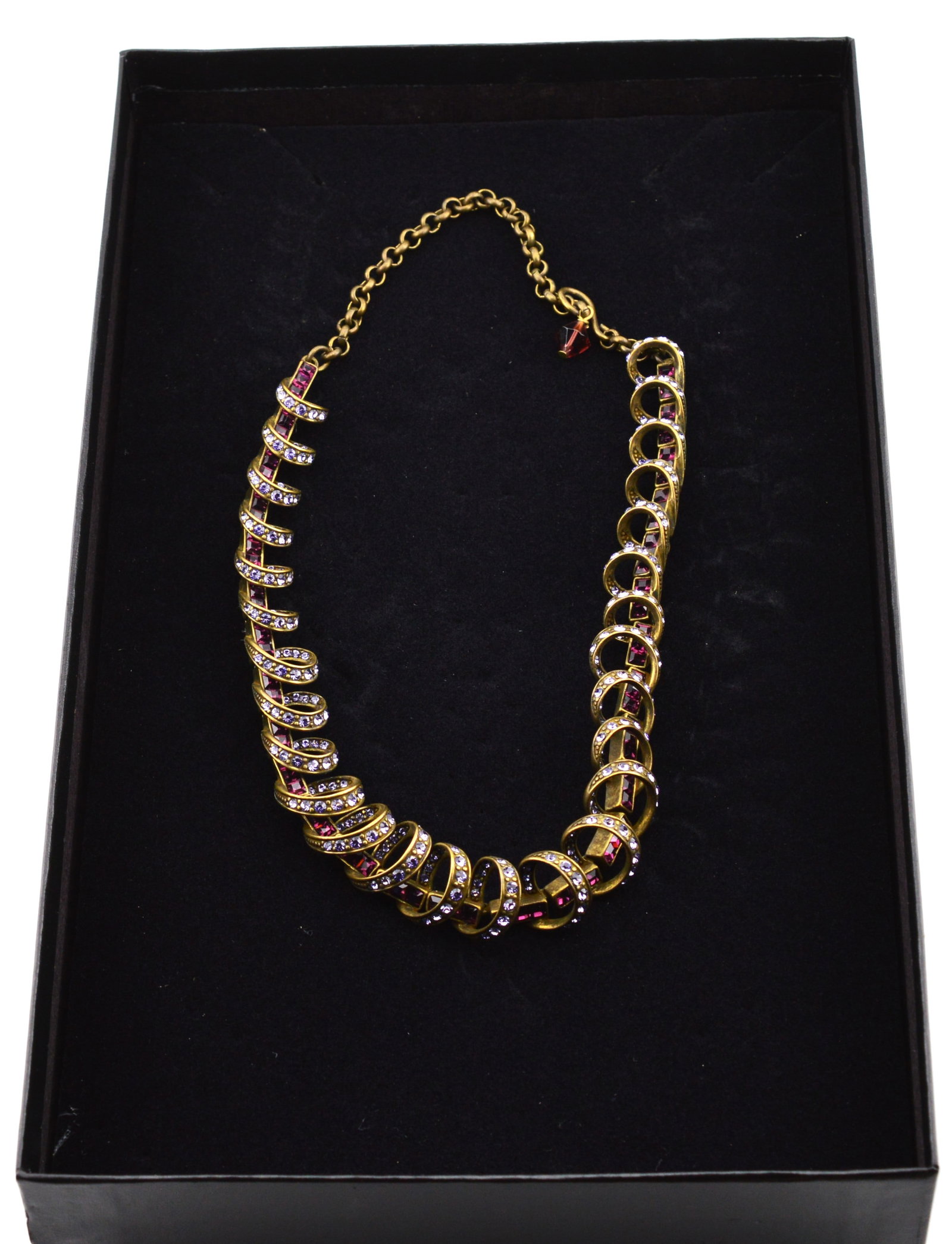 Heidi Daus Fuchsia Lavender Swirl Choker NIB: Antiqued Brass Fuchsia Lavender Swirl Choker NIBMeasures 12 in to 16 in. Graduated swirls are studded with lavender crystal. The largest swirls are .5 in in diameter.NEW IN BOXNBBS20