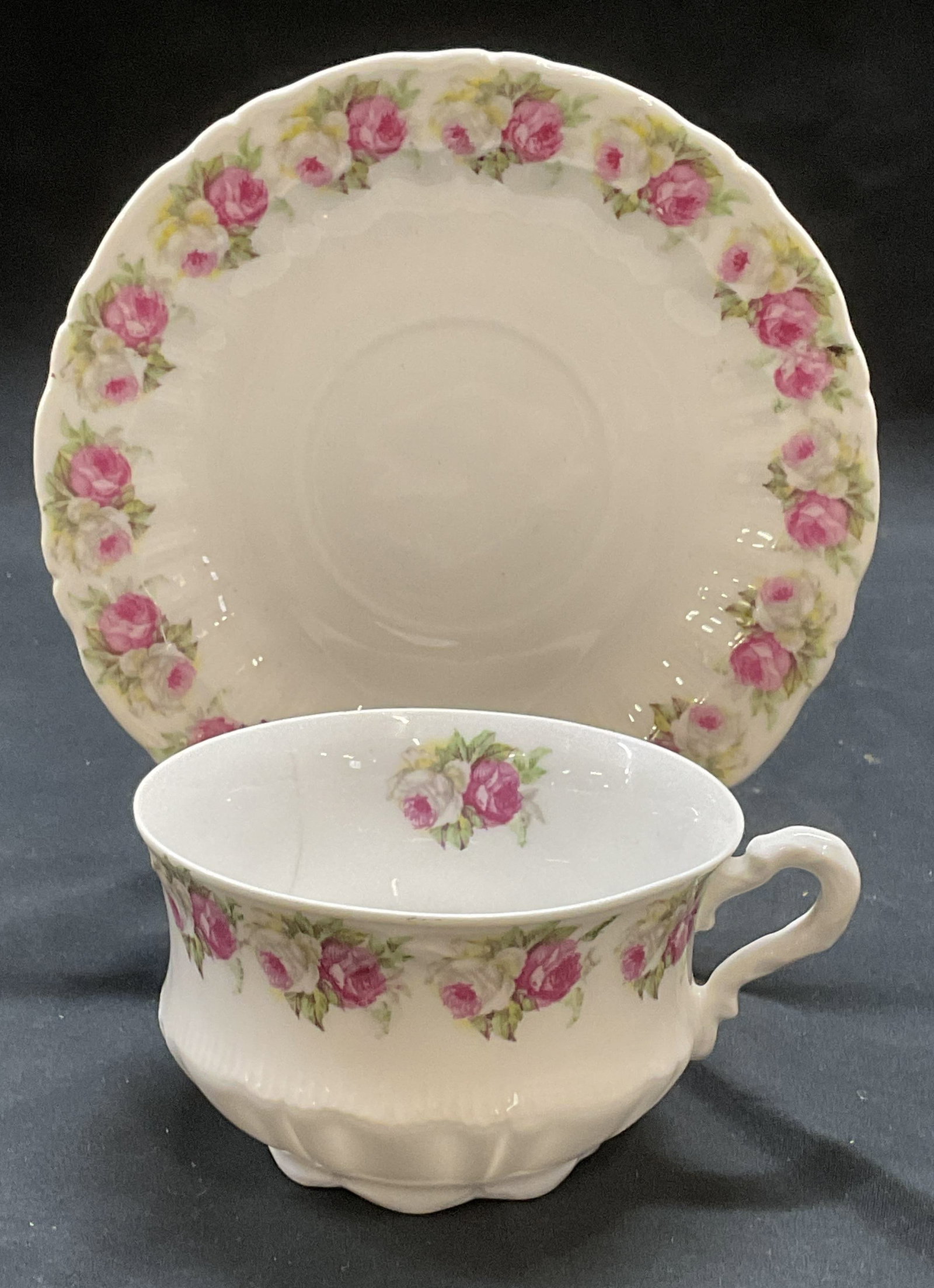 Antique CT Germany Porcelain Teacup & Saucer: Antique CT porcelain teacup and saucer. Floral pattern in pink and white. Trademarked to undersides, made in Germany. Cup measures approx. 3.5 x 2.25 inches. Saucer measures approx. 5.5 inches wide. S