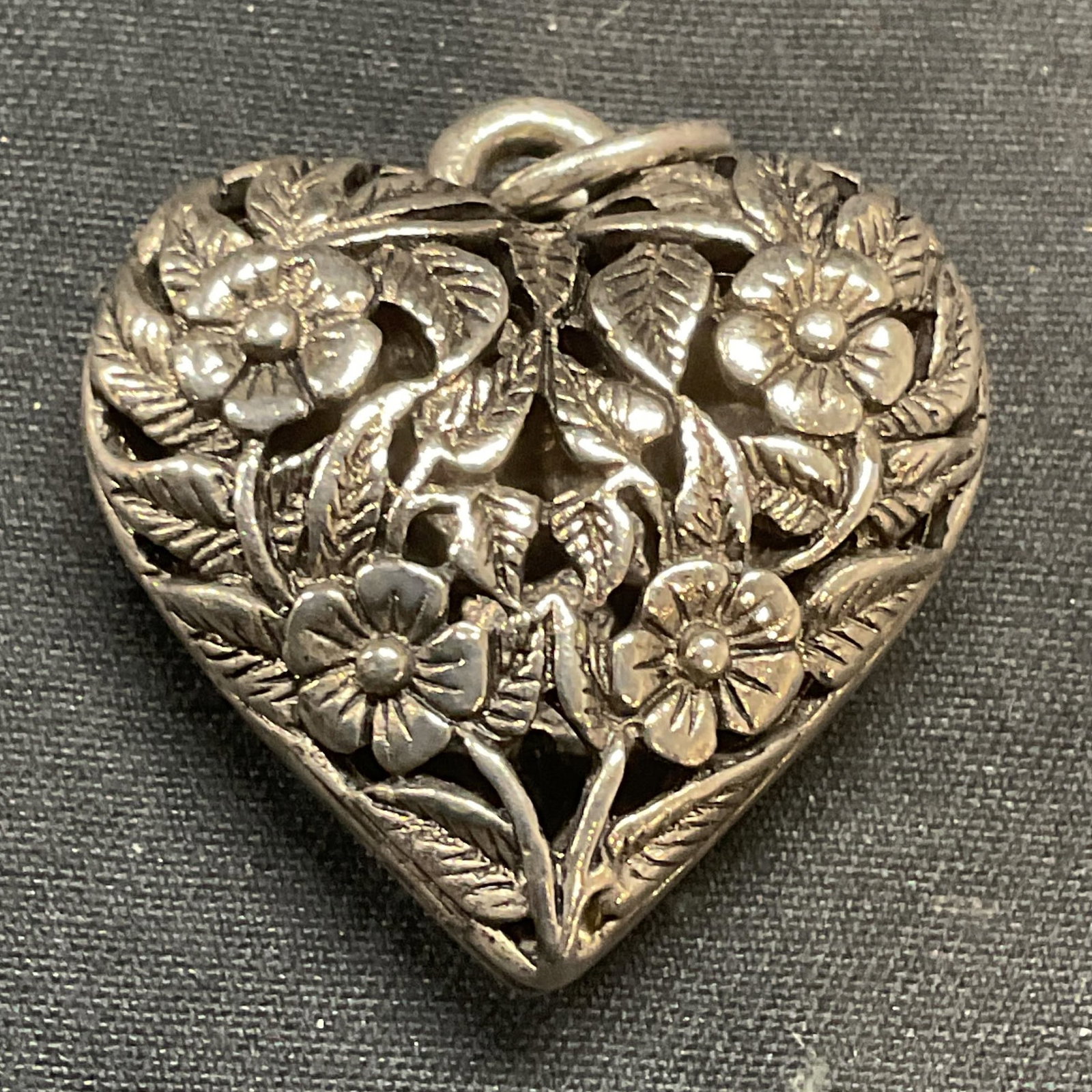 Vintage Silver Plated Heart Pendant Locket: Vintage silver plated heart pendant locket. Pierced floral motif. Measures approx. 1 x 1 inches. Some surface wear including scratching observed. Jewelry, estate jewelry, costume jewelry, cocktail jew