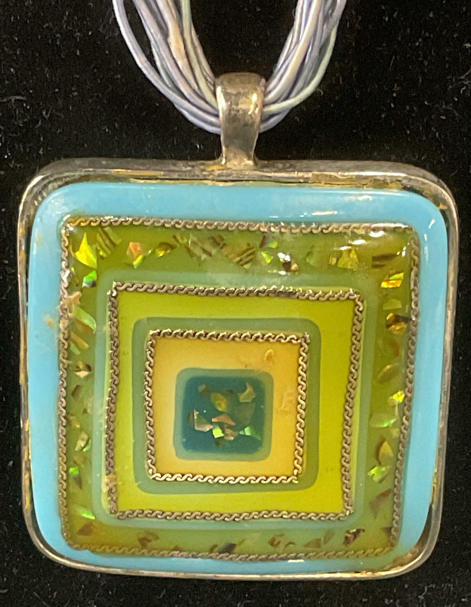 Signed Vintage Blue & Green Pendant Necklace: Signed vintage necklace with blue multi strand cords and silver tone resinous pendant with blue and green toned inlay. Signed R on hang tag. Drop length approx. 10 inches. Pendant measures approx. 2 i