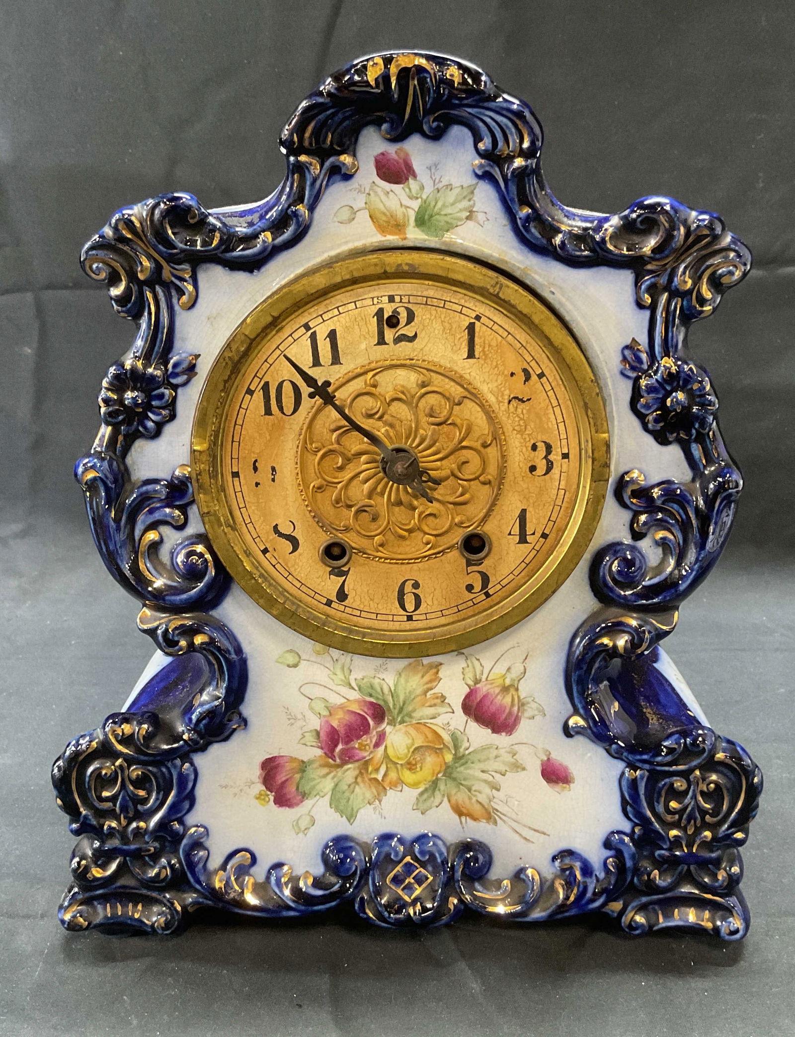 Vintage Blue Porcelain Mantle Clock: Vintage blue porcelain mantle clock with hand painted floral motif. Gilt decoration. Marked no. 92 on reverse. Measures approx. 8 x 5 x 10.5 inches. Dial is not attached to clock base, needs repair. N
