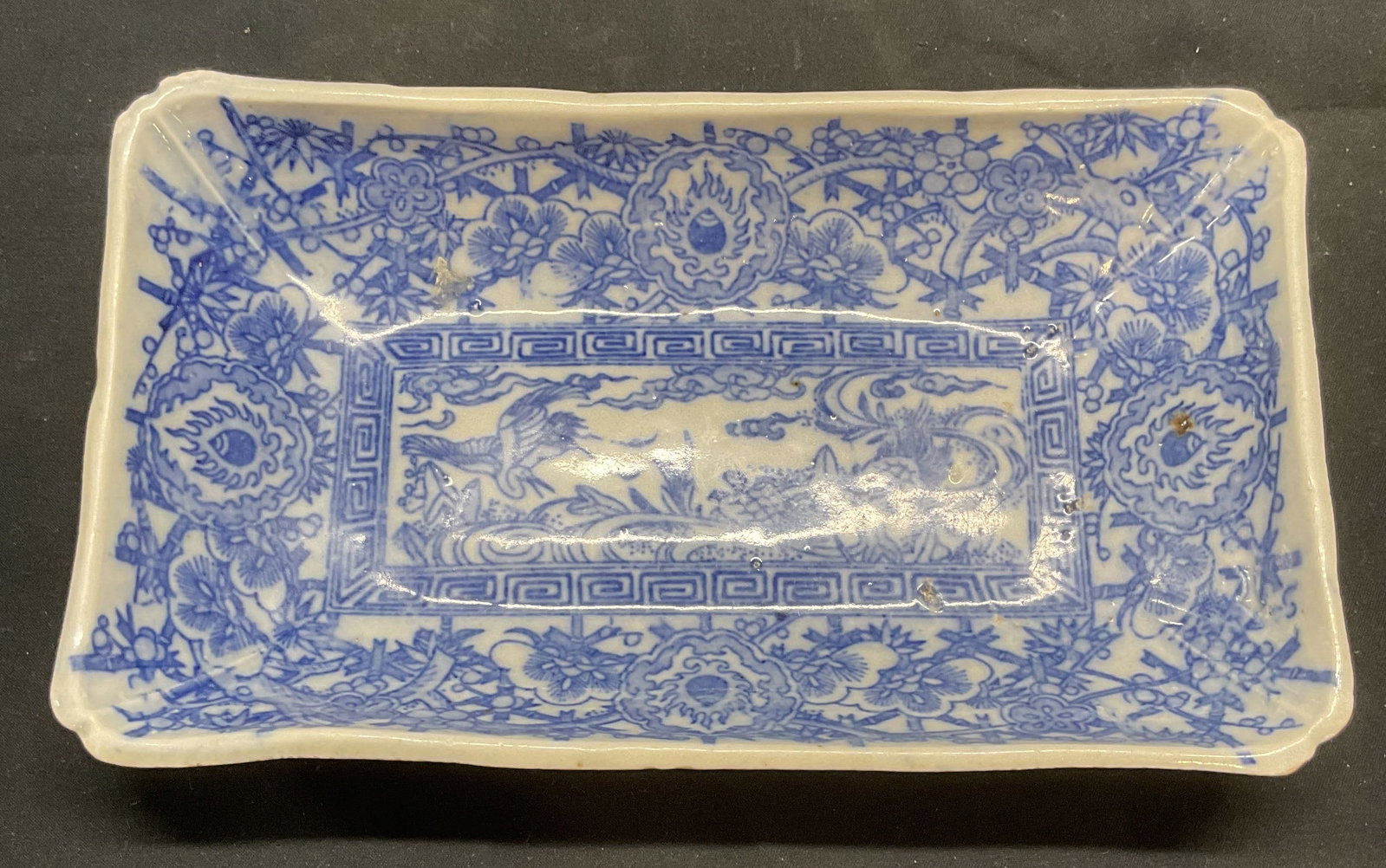 Vintage Blue & White Porcelain Crane & Turtle Dish: Vintage blue and white porcelain dish. Crane and turtle motif with floral botanical border. Measures approx, 7.75 x 4.5 x 1.5 inches. Some surface wear including scratching observed. Blue and white di
