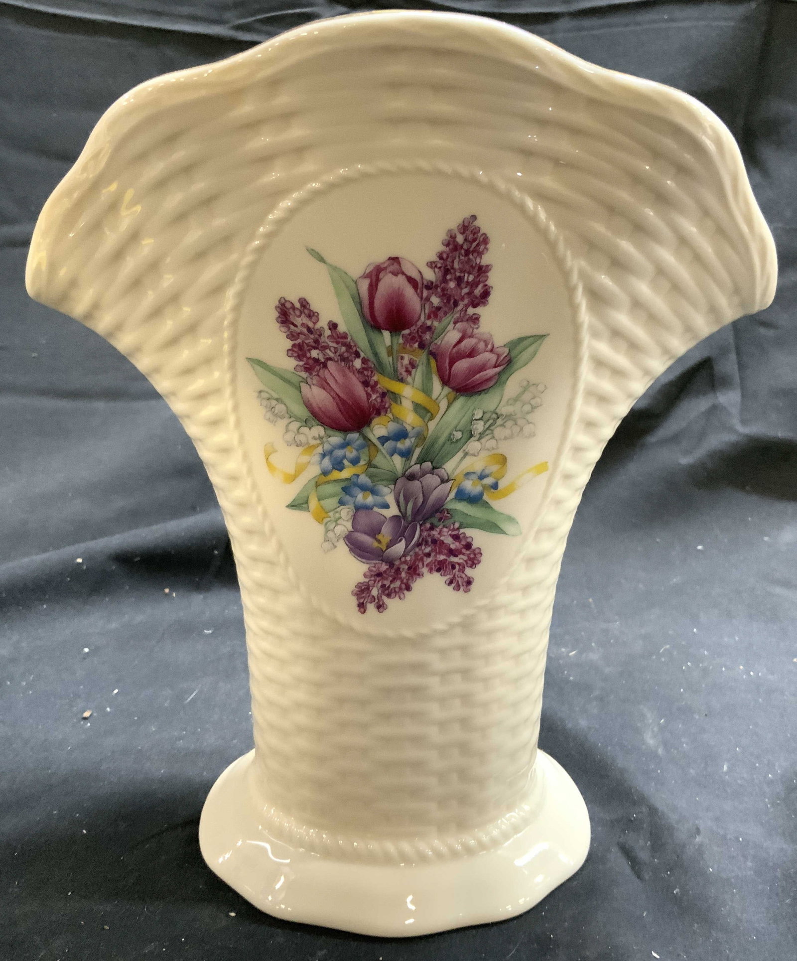 LENOX Springtime Bud Tulip Vase Vessel: Underside reads LENOX. Springtime Tulip vase. Piece is cream toned and porcelain with gilt rim. & multi toned floral and leaf detail. Vase expands outward towards top. Piece measures approximately 8.2