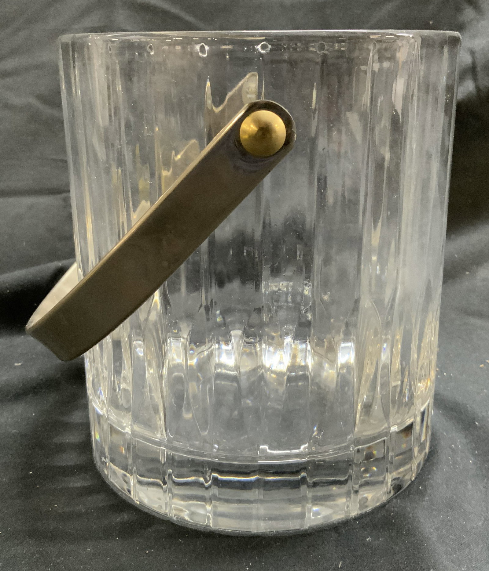 Thick Walled Scalloped Crystal Ice Bucket W Handle: Ice bucket is appears to be Crystal possibly glass. Piece has scalloped exterior. Ice bucket has silver toned metal arched form handle. Piece has very thick walled base. Ice bucket has cylindrical for
