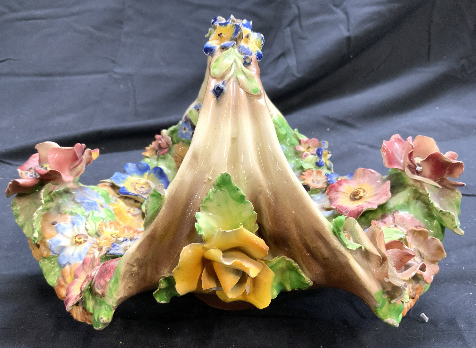 Floral Detailed Ceramic Basket W Handle ITALY: Underside reads ITALY. Basket is ceramic. Piece has intricate multi toned raised floral and leaf detail. Basket has arch form handle. Piece measures approximately 11 inches wide 8 inches. Basket, cera