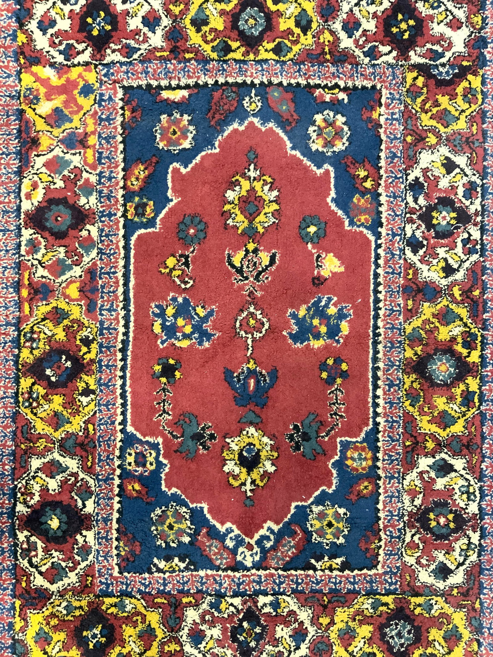 Vintage Handmade Wool Area Rug: Rug is handmade and wool. Piece is vintage. Rug has intricate multi toned floral, leaf, & geometric detail. Some short cream toned fringes present. Piece measures approximately 56 inches long 38 inche