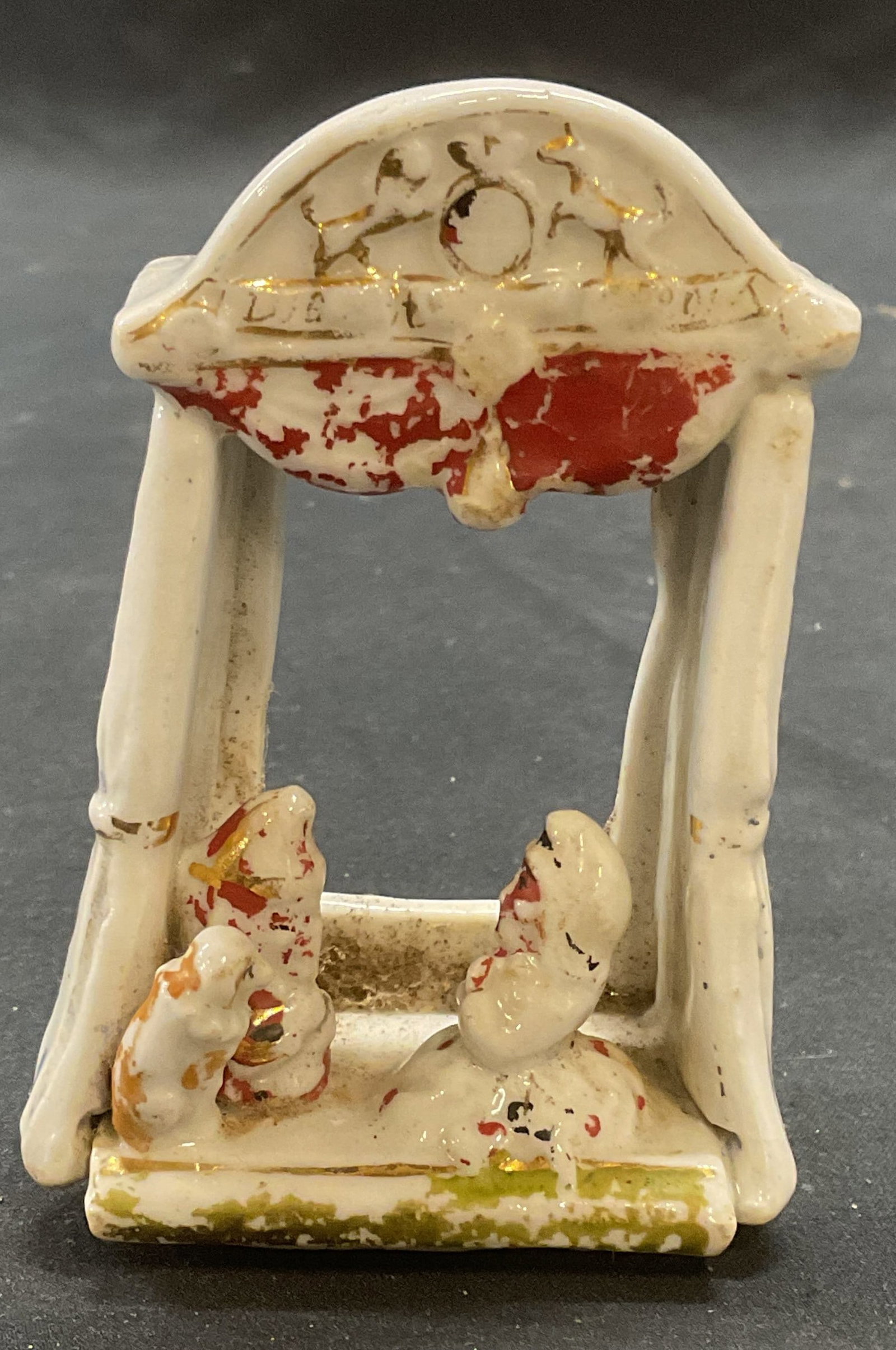 Vintage Porcelain Puppet Theater Figural: Vintage porcelain figural with puppet theater motif. Hand painted with gilt decoration. Measures apples. 2.5 x 1.5 x 3.75 inches. Surface wear including loss to paint observed. Porcelain puppet theate
