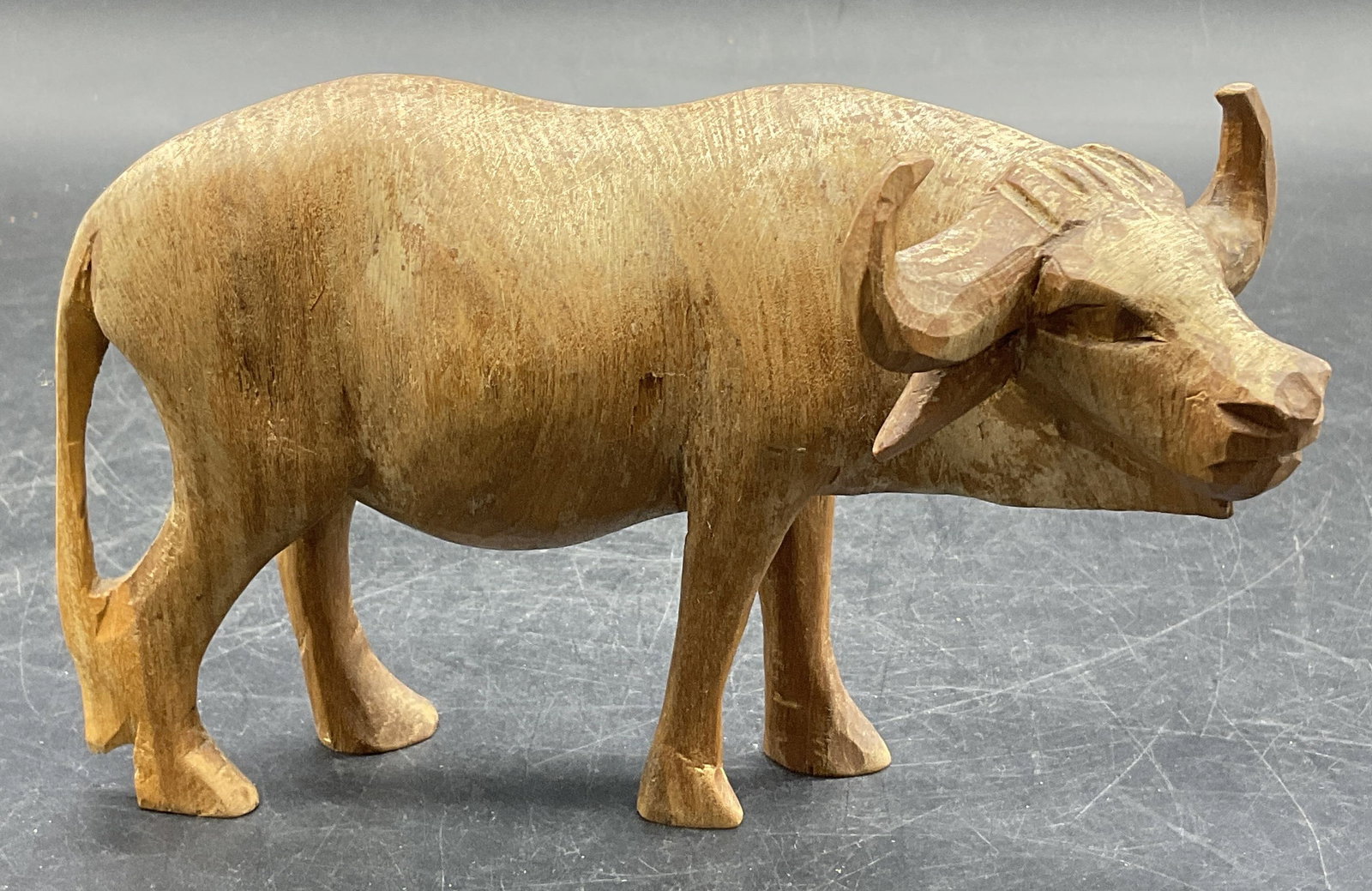 Handcrafted Wooden Buffalo Figural: A handcrafted wooden buffalo figural. Measures approx. 4H x 6W in. Some surface wear and discoloration present. Cracking present. home decor, home accents, homewares, housewares, home accessories, col