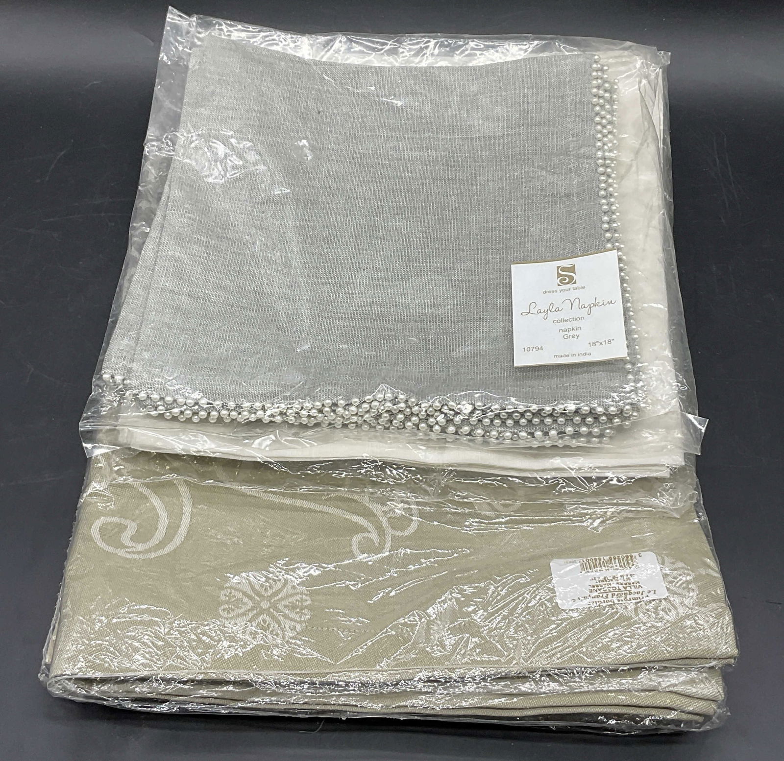 Lot 4 NWT Packaged Table Linens, BODRUM +: Four packaged table linens. Brands include BODRUM, S DRESS YOUR TABLE (LAYLA NAPKIN), and PRIMROSE BORDIER pour LE JACQUARD FRANCAIS (100% Cotton). Lot includes placemats and napkins. Largest package